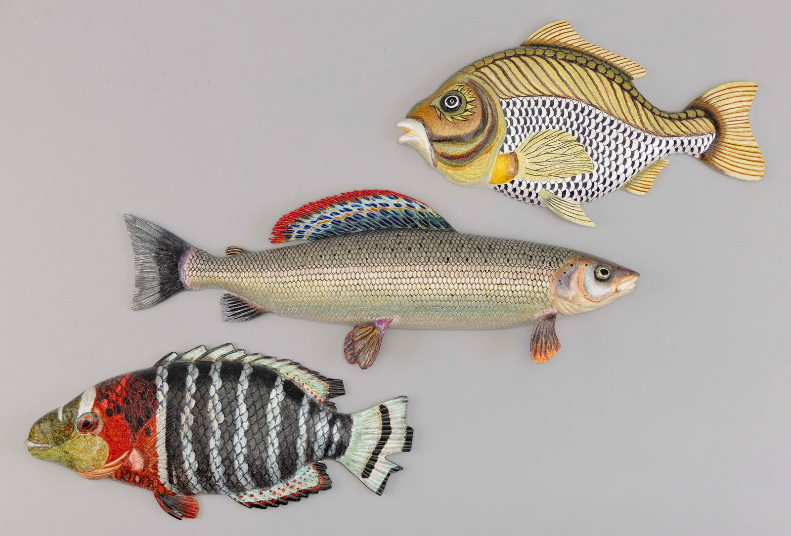 SET OF THREE CARVED AND PAINTED TROPICAL FISH 20th/21st Century Lengths from 14.75" to 19.75".: SET OF THREE CARVED AND PAINTED TROPICAL FISH 20th/21st Century Signed ìJ Lee". Lengths from 14.75" to 19.75".