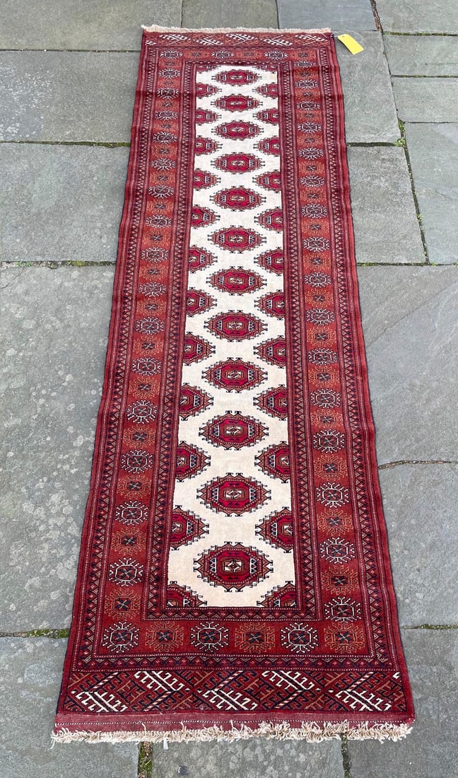 BOKHARA DESIGN RUNNER: 2í9" X 9í3" Late 20th Century: BOKHARA DESIGN RUNNER: 2í9" X 9í3" Late 20th Century Several staggered rows of tribal guls in red, tan, brown, ivory and onyx run the length of a bright ivory field. Typical stylized element