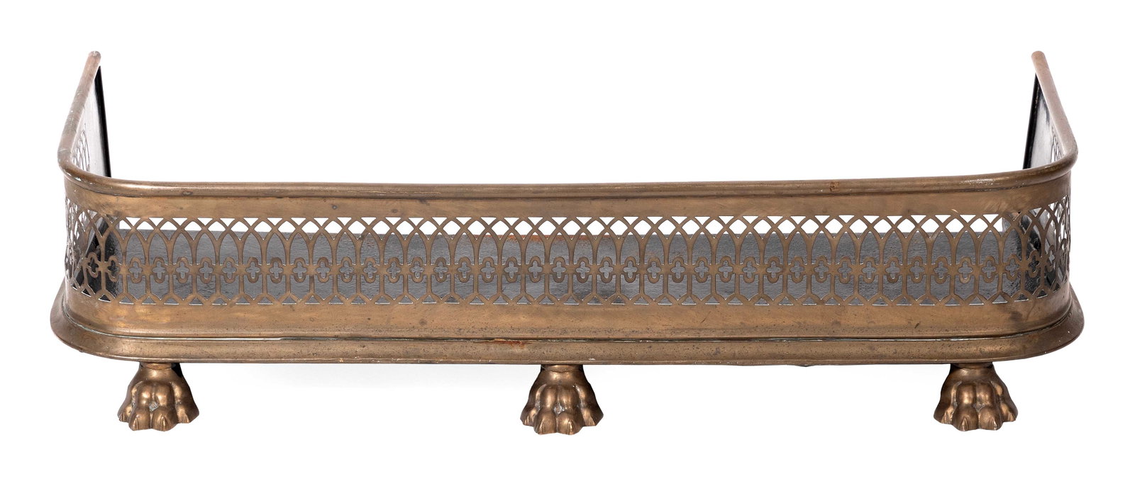 PIERCED BRASS FIRE FENDER 19th Century Height 8.25". Width 33.25". Depth 13.75".: PIERCED BRASS FIRE FENDER 19th Century Three paw feet. Height 8.25". Width 33.25". Depth 13.75".