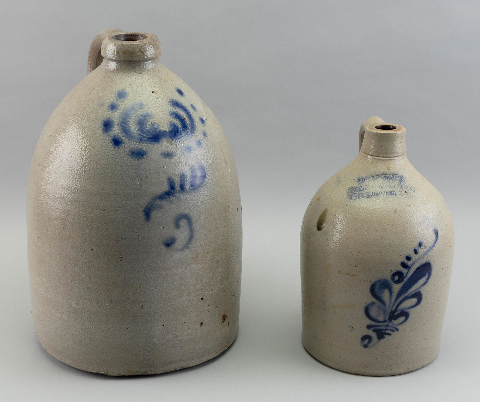 TWO STONEWARE JUGS 19th Century Heights 12" and 16". (1 of 2)