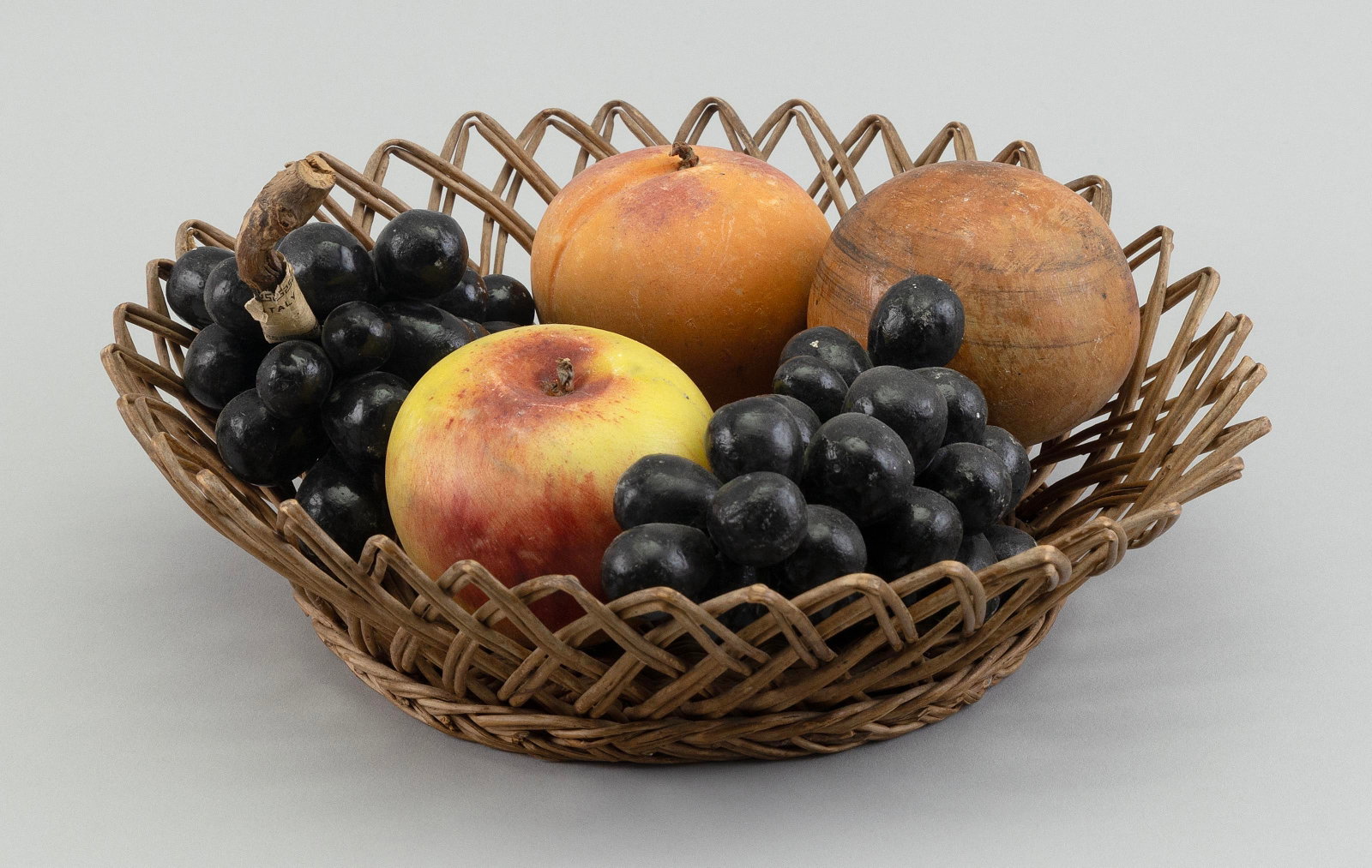 BASKET CONTAINING FIVE PIECES OF STONE FRUIT 20th Century Basket diameter 10.75".: BASKET CONTAINING FIVE PIECES OF STONE FRUIT 20th Century Basket diameter 10.75".