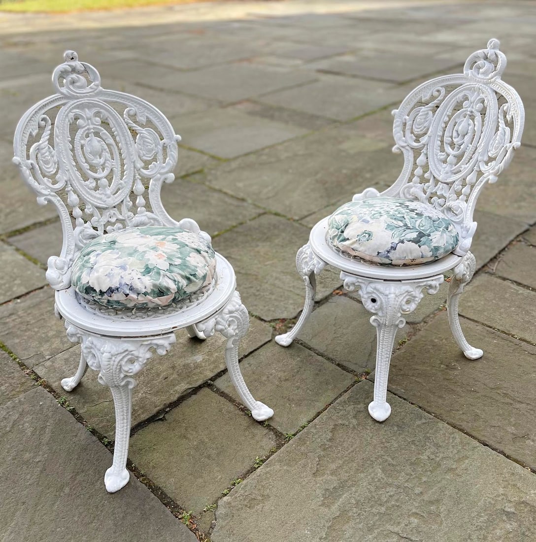 PAIR OF CAST IRON GARDEN CHAIRS Early 20th Century Back heights 32". Seat heights 14.5". (1 of 3)