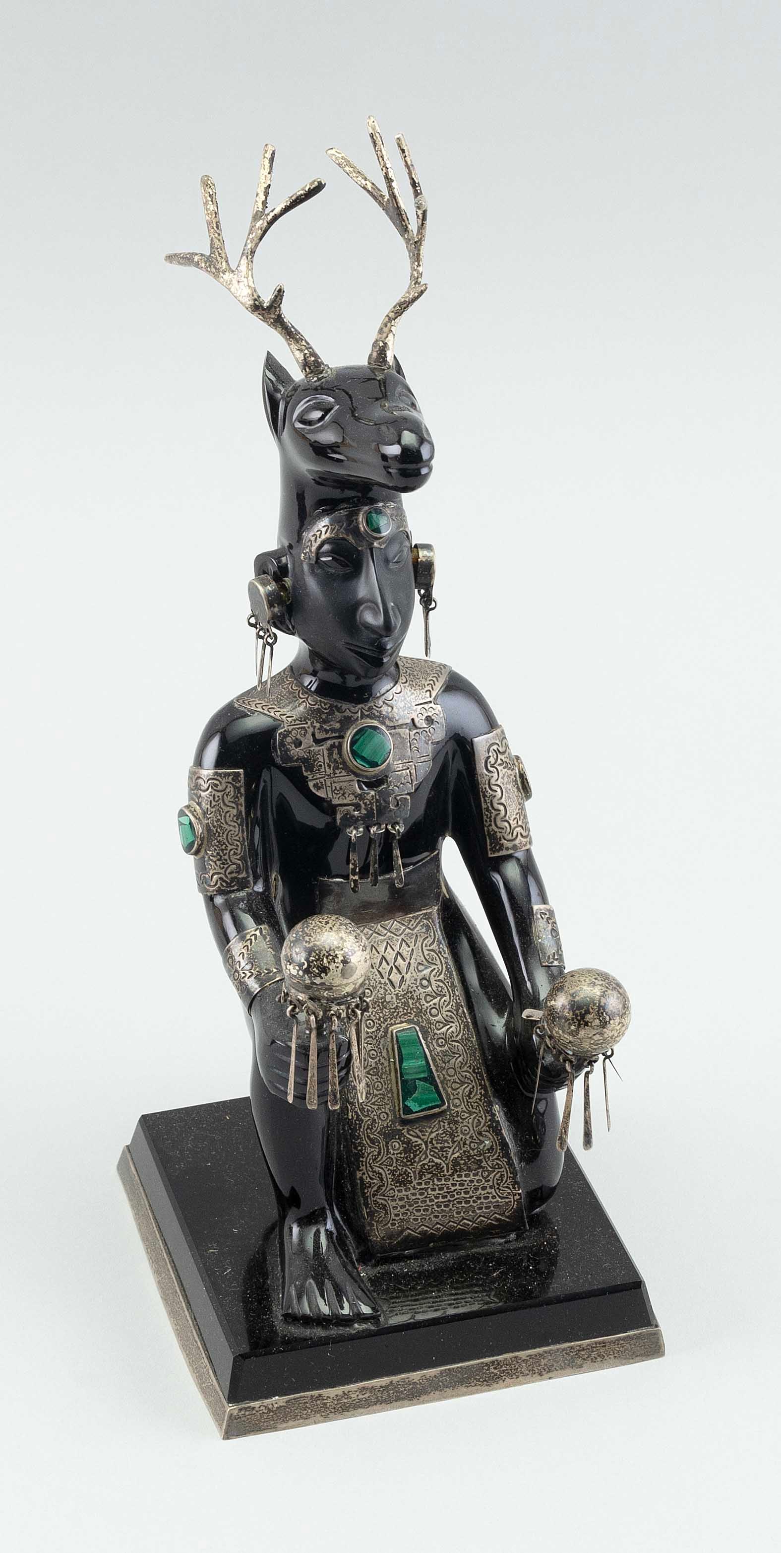 OBSIDIAN, SILVER AND MALACHITE GOD FIGURE Mexico, 20th Century Height 11".: OBSIDIAN, SILVER AND MALACHITE GOD FIGUREMexico, 20th CenturyObsidian kneeling figure with animal headdress. Silver and malachite enhancements.Height 11".
