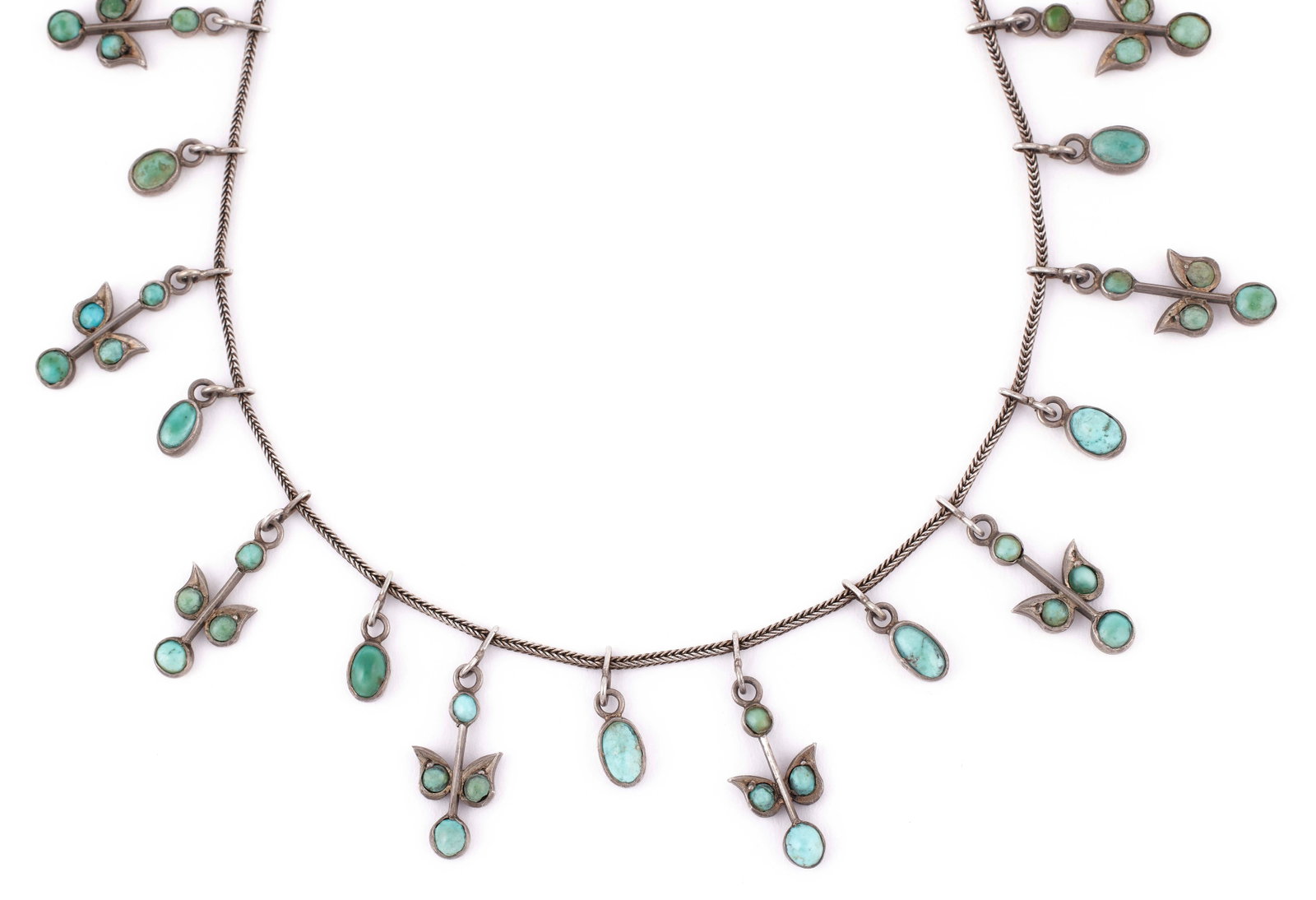 SILVER AND TURQUOISE NECKLACE Approx. 10.67 total dwt.: SILVER AND TURQUOISE NECKLACE 11 leaf-design drops alternating with 12 small oval drops. Length 17". Approx. 10.67 total dwt.
