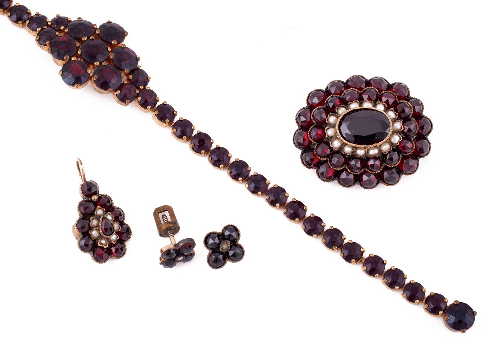 VINTAGE FIVE-PIECE GARNET PARURE: VINTAGE FIVE-PIECE GARNET PARURE Includes a link bracelet, length approx. 7.5”, a pair of threaded post earrings, a pendant with pearls and an oval pin/pendant with pearls.