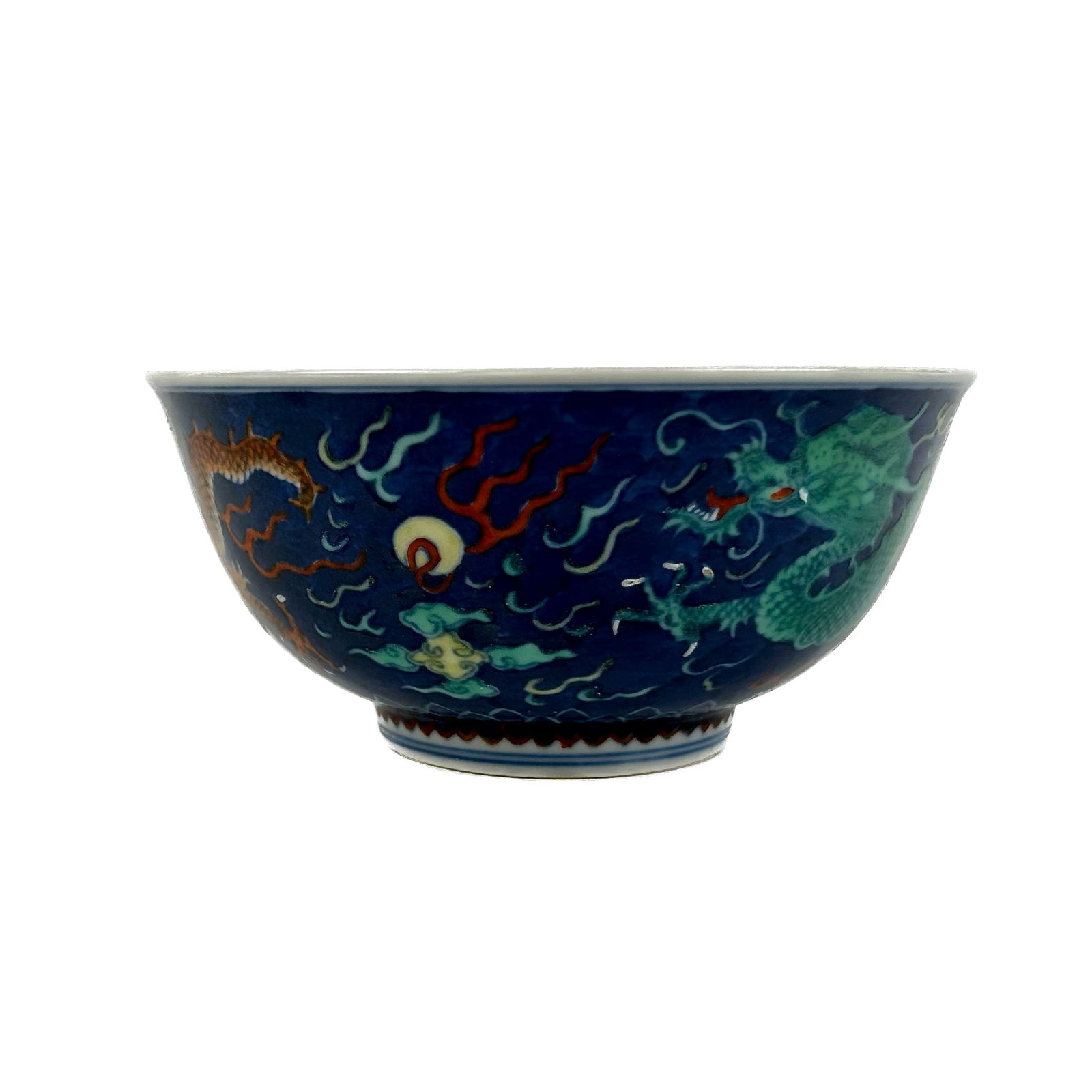 CHINESE POLYCHROME PORCELAIN DRAGON BOWL Late 19th/Early 20th Century Height 3". Diameter 6".: CHINESE POLYCHROME PORCELAIN DRAGON BOWLLate 19th/Early 20th CenturyGreen and salmon five-clawed dragons chasing a fiery yellow pearl against a blue ground. Interior with similar rondel. Six-character