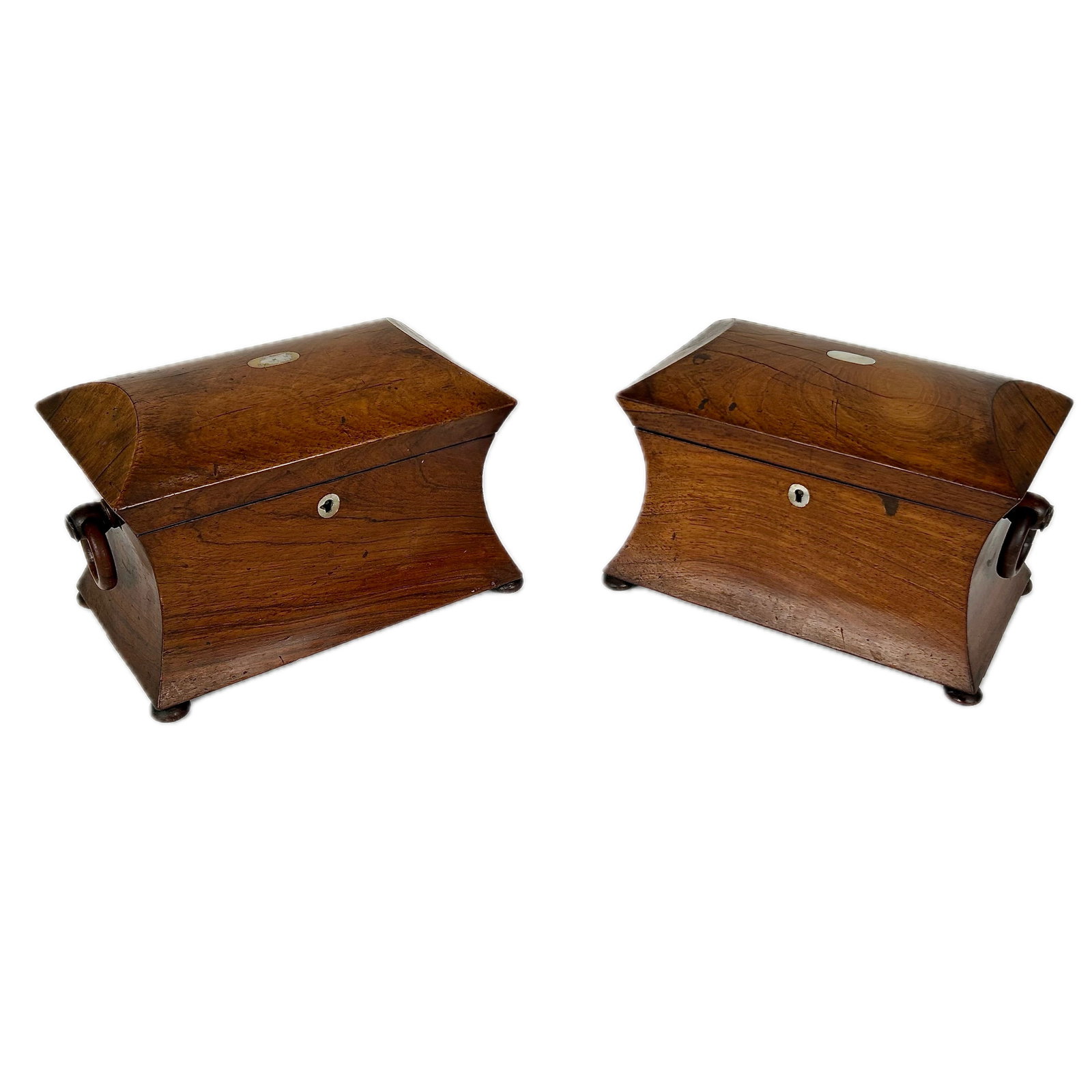 PAIR OF ENGLISH TEA CADDIES 19th Century Heights 6". Widths 10.5". Depths 6".: PAIR OF ENGLISH TEA CADDIES 19th Century In mahogany, with wooden ring handles at sides, fitted interiors and ball feet. Heights 6". Widths 10.5". Depths 6".