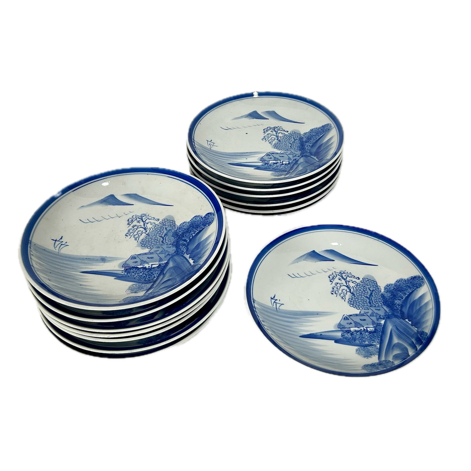 COLLECTION OF FOURTEEN JAPANESE BLUE AND WHITE PORCELAIN DISHES 20th Century Plate diameters 9.5".: COLLECTION OF FOURTEEN JAPANESE BLUE AND WHITE PORCELAIN DISHES 20th Century With mountain and village decoration. Includes original shipping crate. Plate diameters 9.5".
