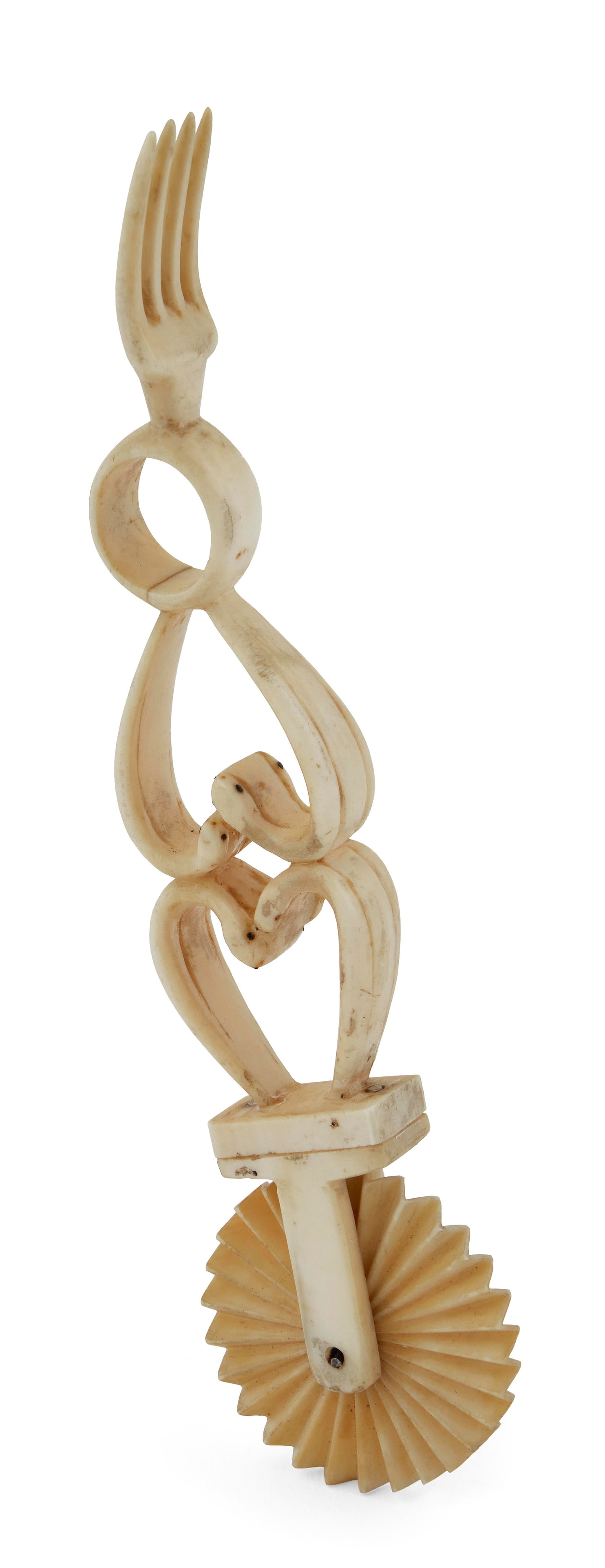 WHALE IVORY OPPOSING HEARTS PIE CRIMPER Mid-19th Century Length 6.25". With contemporary stand.: WHALE IVORY OPPOSING HEARTS PIE CRIMPER Mid-19th Century Shaft and four-tine fork carved from a single piece of ivory. Shaft in an openwork design of two opposing hearts and a circle, the hearts subtl