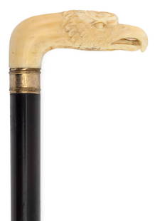 WALRUS IVORY EAGLE'S HEAD CANE Late 19th Century Length 33".: WALRUS IVORY EAGLE'S HEAD CANE Late 19th Century Well-carved eagle with layers of feathers, penetrating eyes, a crooked beak and a slightly open mouth revealing its tongue. Unmarked collar possibly