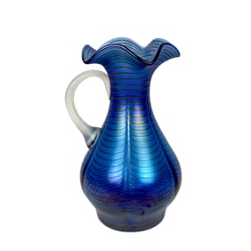 BLUE IRIDESCENT ART GLASS PITCHER Late 20th Century Height 9.5". Width 5.75".