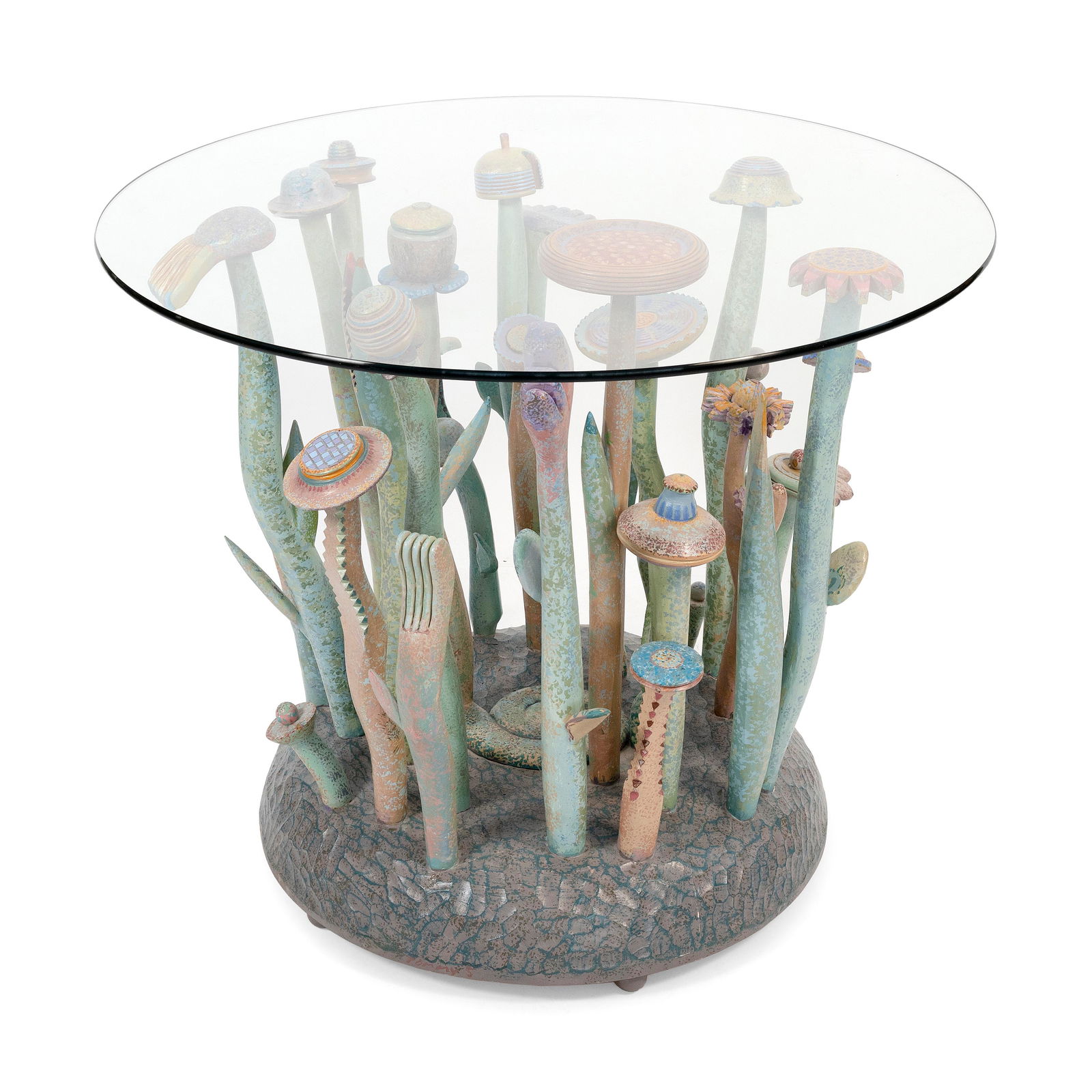 TOMMY SIMPSON (America, 1939-), Kore, 2014., Poplar, basswood, acrylic and glass, height 30". Base: TOMMY SIMPSONAmerica, 1939-Kore, 2014. Art furniture table with a whimsically carved and painted pedestal of flowers and mushrooms emanating from a chip-carved base.Poplar, basswood, acrylic and glass