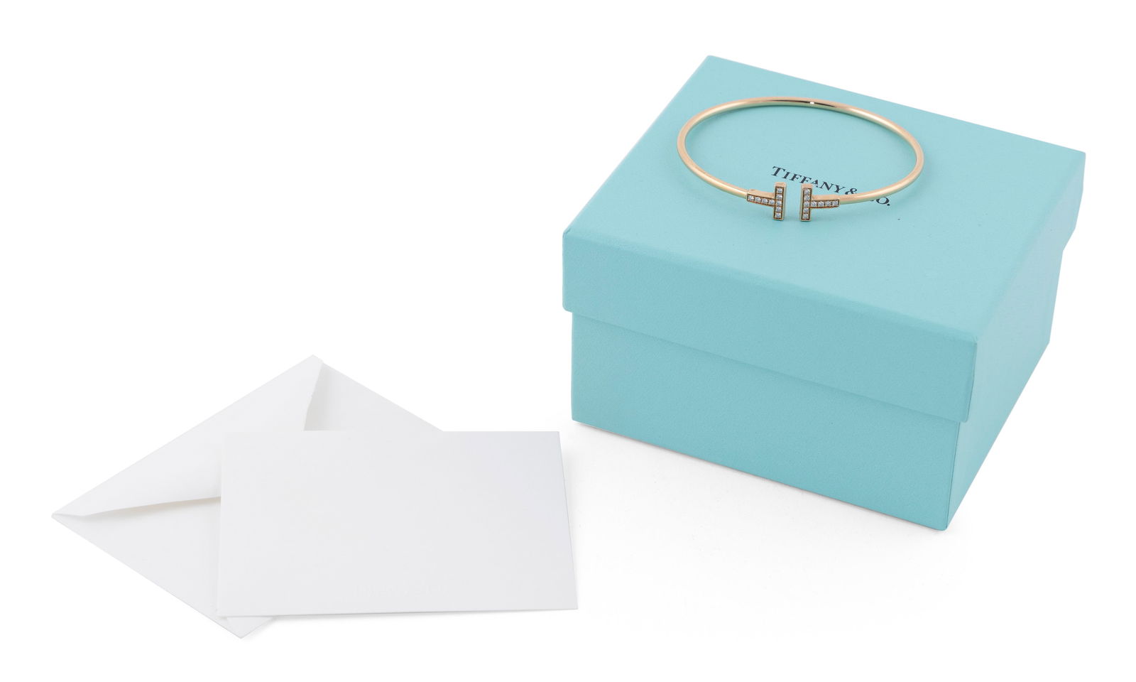 TIFFANY & CO. "TIFFANY T" 18KT ROSE GOLD AND DIAMOND BANGLE Approx. 5.34 total dwt. (1 of 2)