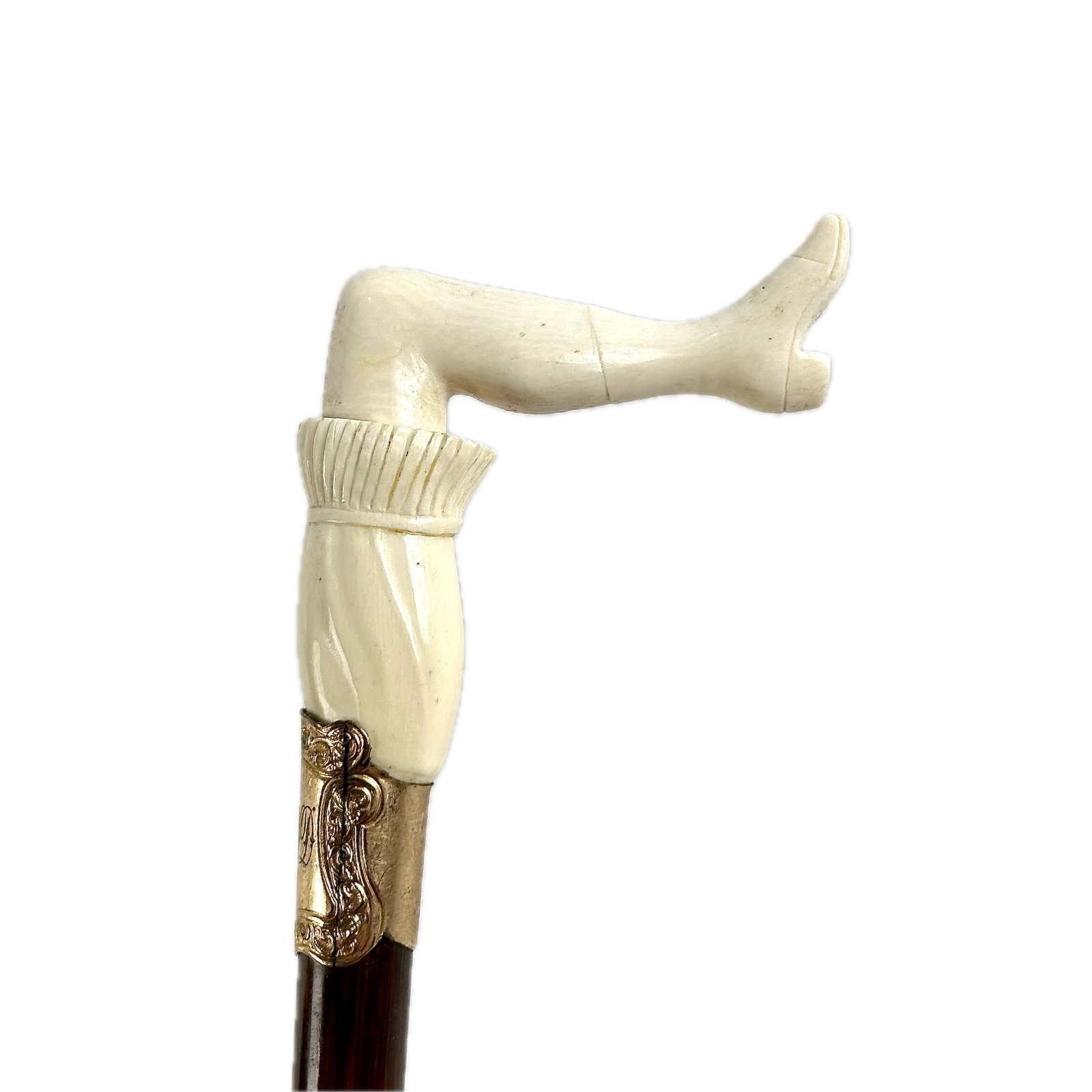LADY'S LEG CANE Late 19th Century Length 36.5".: LADY'S LEG CANE Late 19th Century L-shaped ivory or bone handle carved as a woman's bare leg, ruffled bloomers and healed boot. Nicely detailed execution of the common "Naughty Nellie" motif. Gold-ton