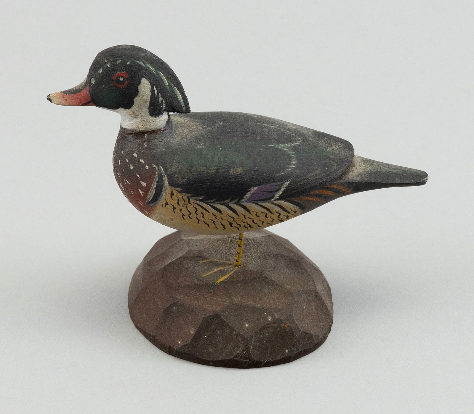 A. ELMER CROWELL MINIATURE WOOD DUCK DRAKE East Harwich, Massachusetts, 1862-1952 Height 3.25".: A. ELMER CROWELL MINIATURE WOOD DUCK DRAKEEast Harwich, Massachusetts, 1862-1952Circa 1930. Mounted on a round chip-carved base. Rectangular stamp on underside.Height 3.25".