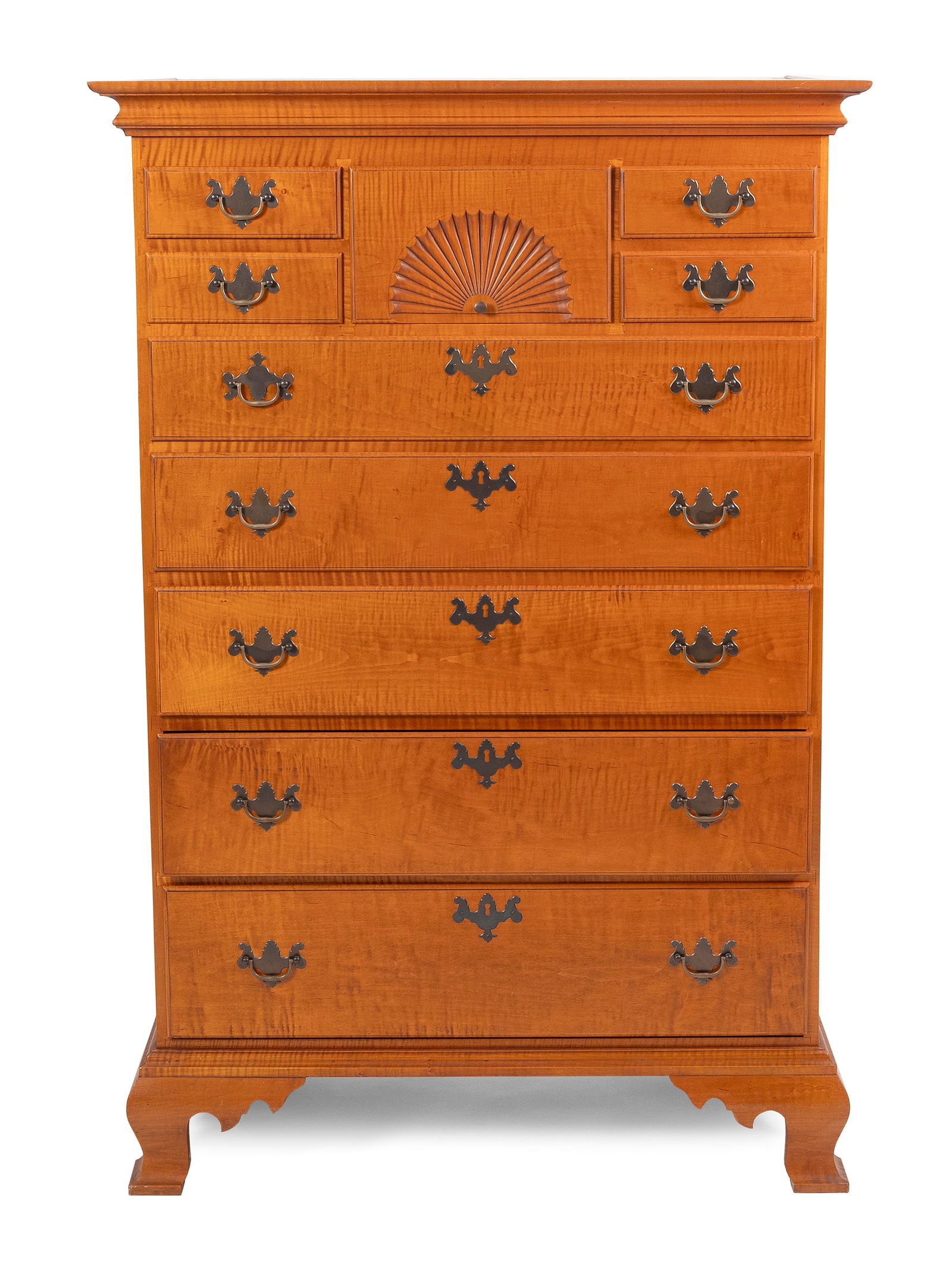 ELDRED WHEELER TALL CHEST Massachusetts, 20th Century Height 55.75". Width 37". Depth 19.25".: ELDRED WHEELER TALL CHESTMassachusetts, 20th CenturyIn tiger maple. Ten varied drawers, including one with a fan carving. Ogee bracket feet. Original Eldred Wheeler paper label inside a drawer.Height