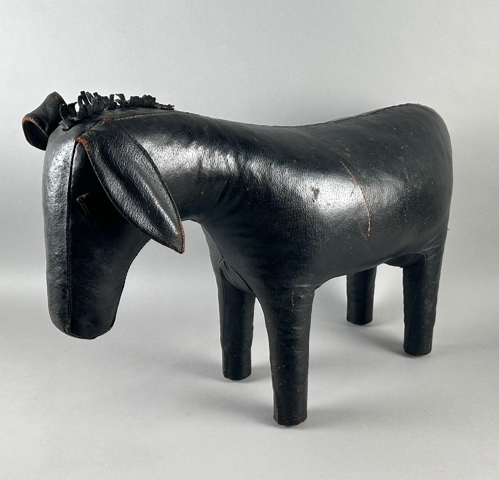 LEATHER DONKEY FOOTSTOOL IN THE STYLE OF DIMITRI OMERSA FOR ABERCROMBIE & FITCH Last Half of the (1 of 2)
