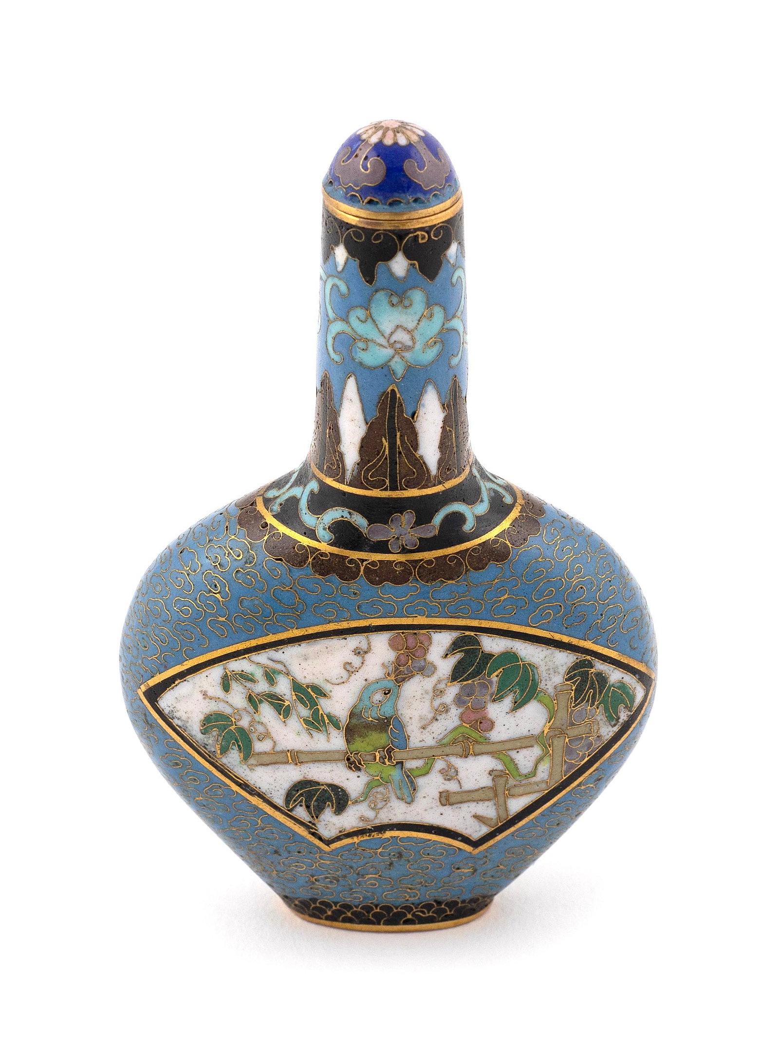CHINESE CLOISONNE SNUFF BOTTLE Early 20th Century Height 3.75". Conforming lotus stopper.: CHINESE CLOISONNE SNUFF BOTTLE Early 20th Century Spade form with elongated neck. Body with fan-form vignettes, one containing bird on bamboo and the other a mountainous village landscape with footbri