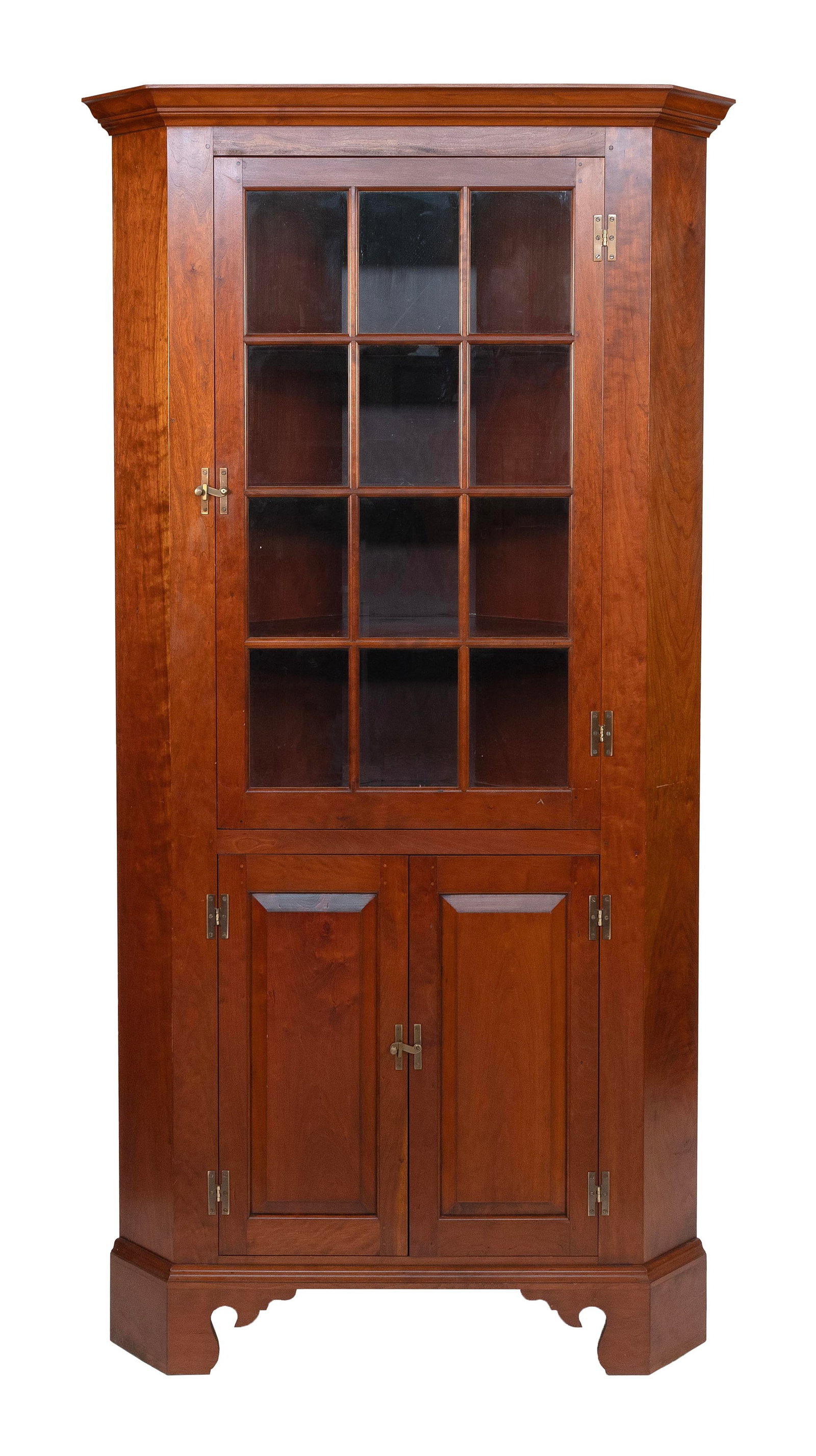 CUSTOM-MADE CORNER CUPBOARD ATTRIBUTED TO ELDRED WHEELER 20th Century Height 84". Width 46". Takes a: CUSTOM-MADE CORNER CUPBOARD ATTRIBUTED TO ELDRED WHEELER20th CenturyIn maple, with a paneled glass door over two paneled doors and a high bracket base. One-piece construction.Height 84". Width 46". Ta