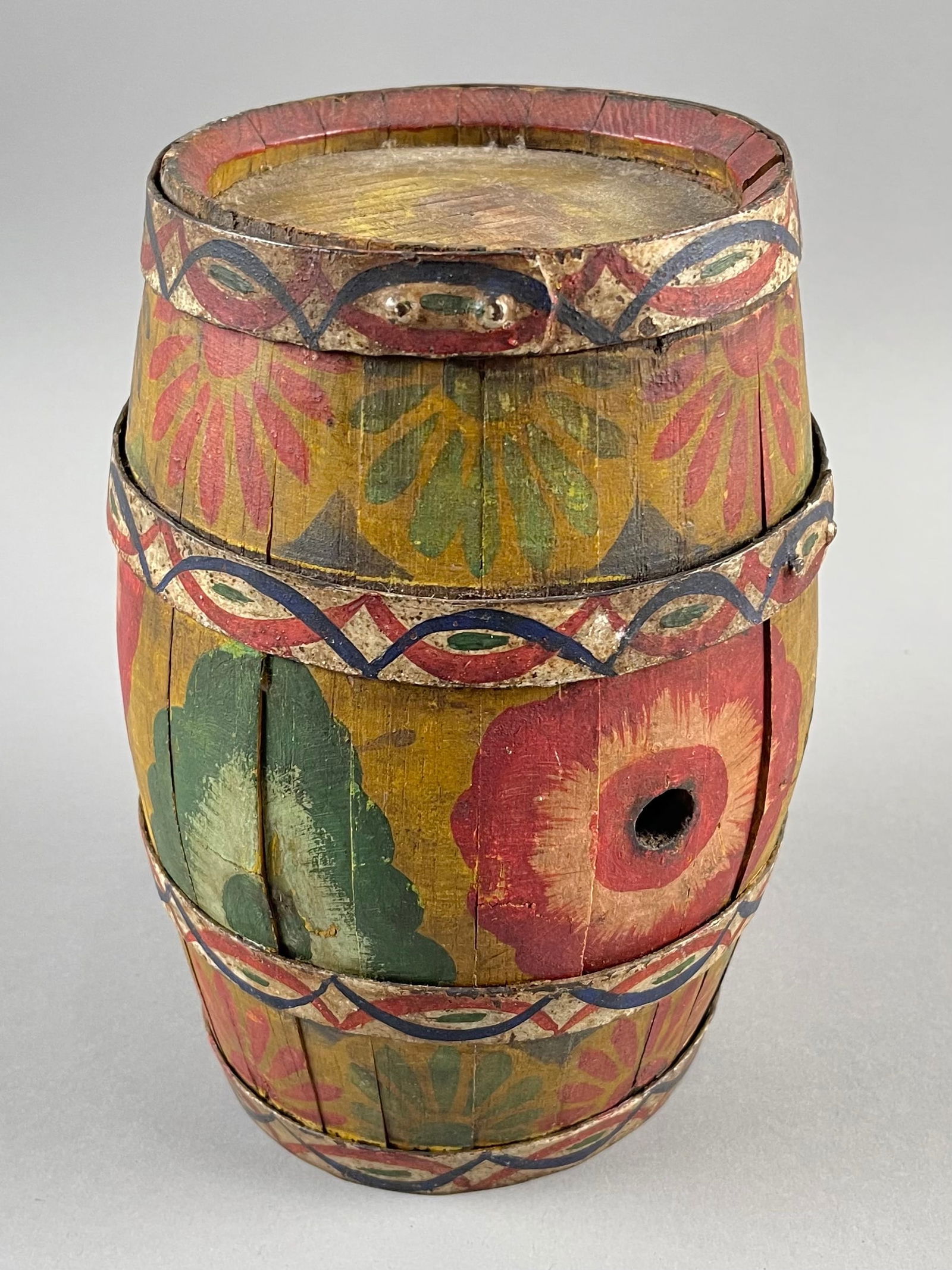 PETER HUNT (Massachusetts, 1896-1967), Iron-banded wooden keg with, Height 9.5".: PETER HUNTMassachusetts, 1896-1967Iron-banded wooden keg with red, yellow, blue and green painted decoration against a white ground.Height 9.5".