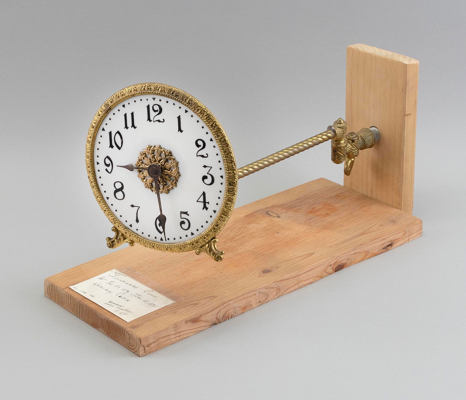 ILLUMINATED WINDUP CLOCK, POSSIBLY WATERBURY CLOCK COMPANY Late 19th Century Stand length 12.5". (1 of 2)