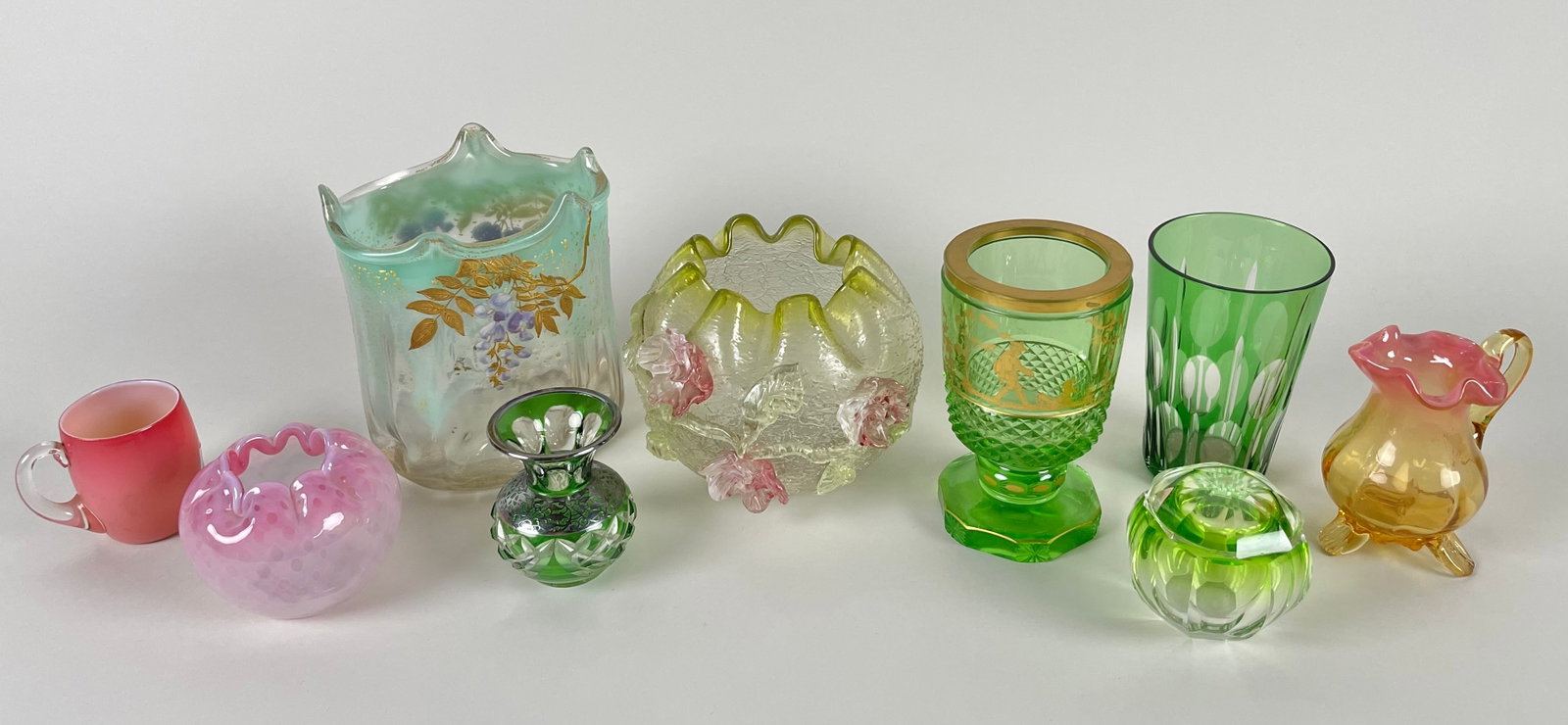 NINE PIECES OF COLORED GLASS, MOSTLY ENGLISH 19th Century Heights from 3" to 6.5".: NINE PIECES OF COLORED GLASS, MOSTLY ENGLISH 19th Century 1-6) Six vases. 7) Dresser jar. 8) Handled mug. 9) Small pitcher. Heights from 3" to 6.5".