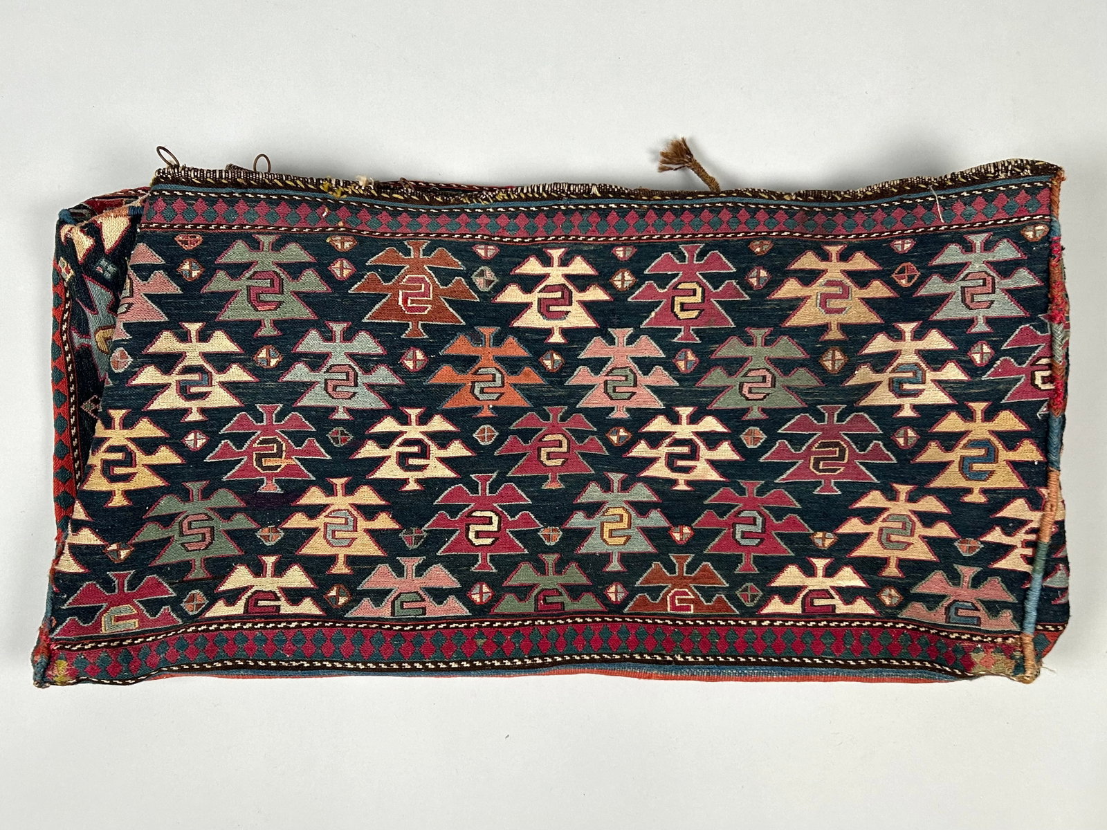 SOUMAC MAFRASH BEDDING BAG: 1'7" X 3'2" X 1'6" Late 19th/Early 20th Century: SOUMAC MAFRASH BEDDING BAG: 1'7" X 3'2" X 1'6" Late 19th/Early 20th Century Navy blue field with staggered rows of a stylized repeating shrub motif in shades of wine red, ivory, brown, blue, green, fa