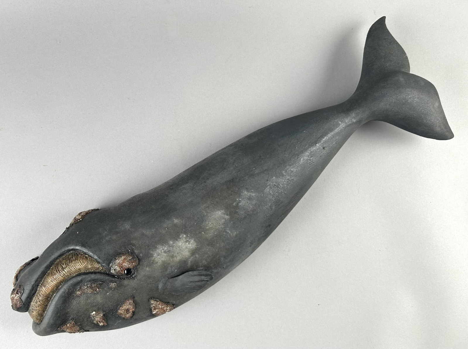 ROGER MITCHELL CARVED WOODEN RIGHT WHALE PLAQUE Massachusetts, 20th Century Length 23".: ROGER MITCHELL CARVED WOODEN RIGHT WHALE PLAQUE Massachusetts, 20th Century Signed on back "RC Mitchell". Length 23".