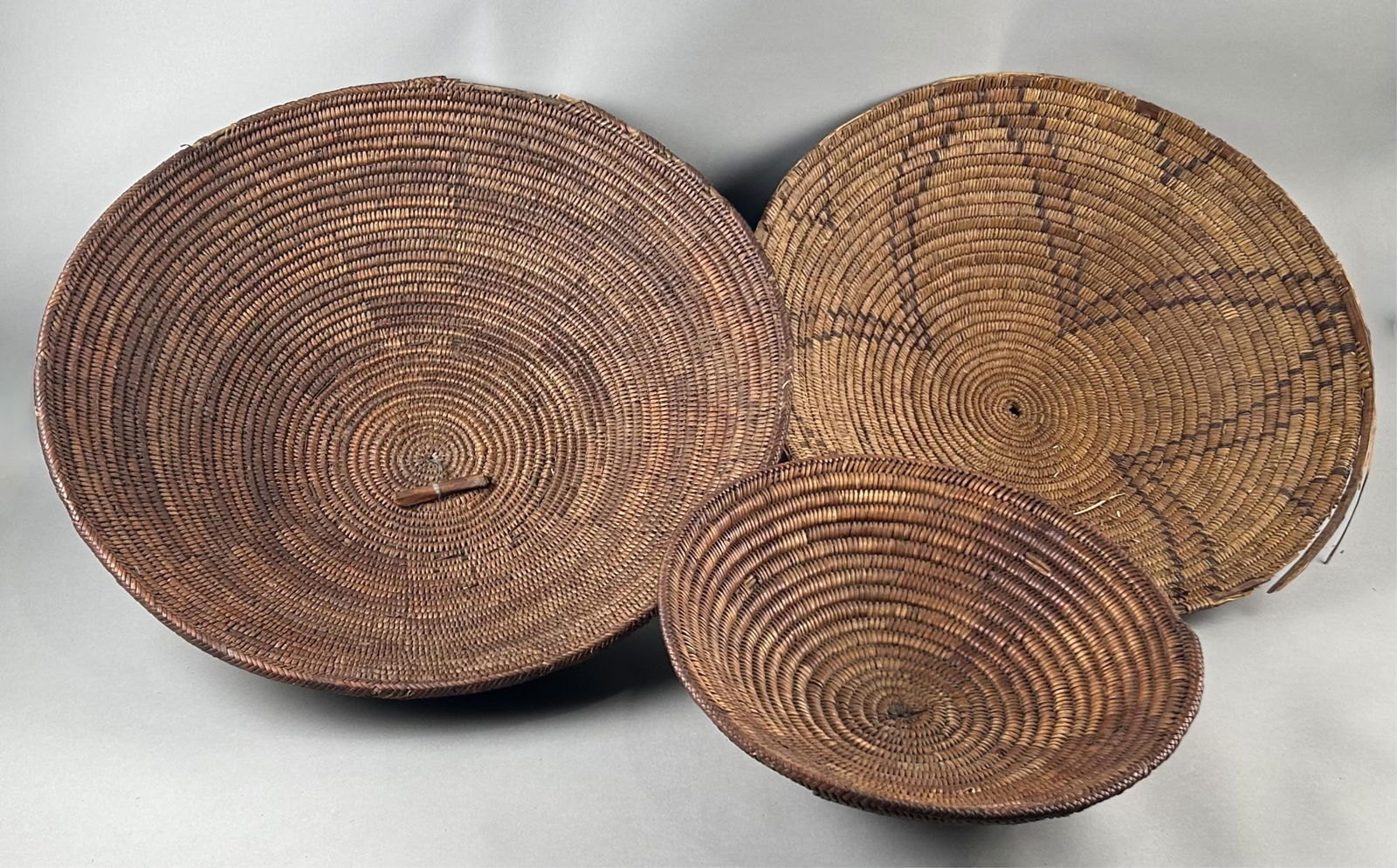 THREE NATIVE AMERICAN WOVEN BASKETS 19th Century Diameters from 15" to 23". (1 of 4)