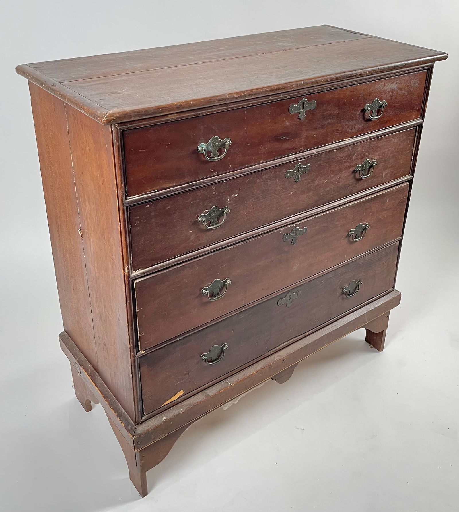 CHIPPENDALE FOUR-DRAWER BUREAU 19th Century Height 41.5". Width 40". Depth 19".: CHIPPENDALE FOUR-DRAWER BUREAU19th CenturyIn maple under an old brown finish. Shaped bracket base.Height 41.5". Width 40". Depth 19".