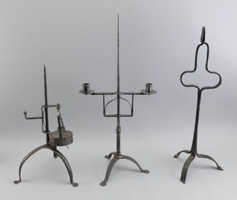 THREE WROUGHT IRON LIGHTING DEVICES 19th Century or Earlier Heights from 17.25" to 23.75".