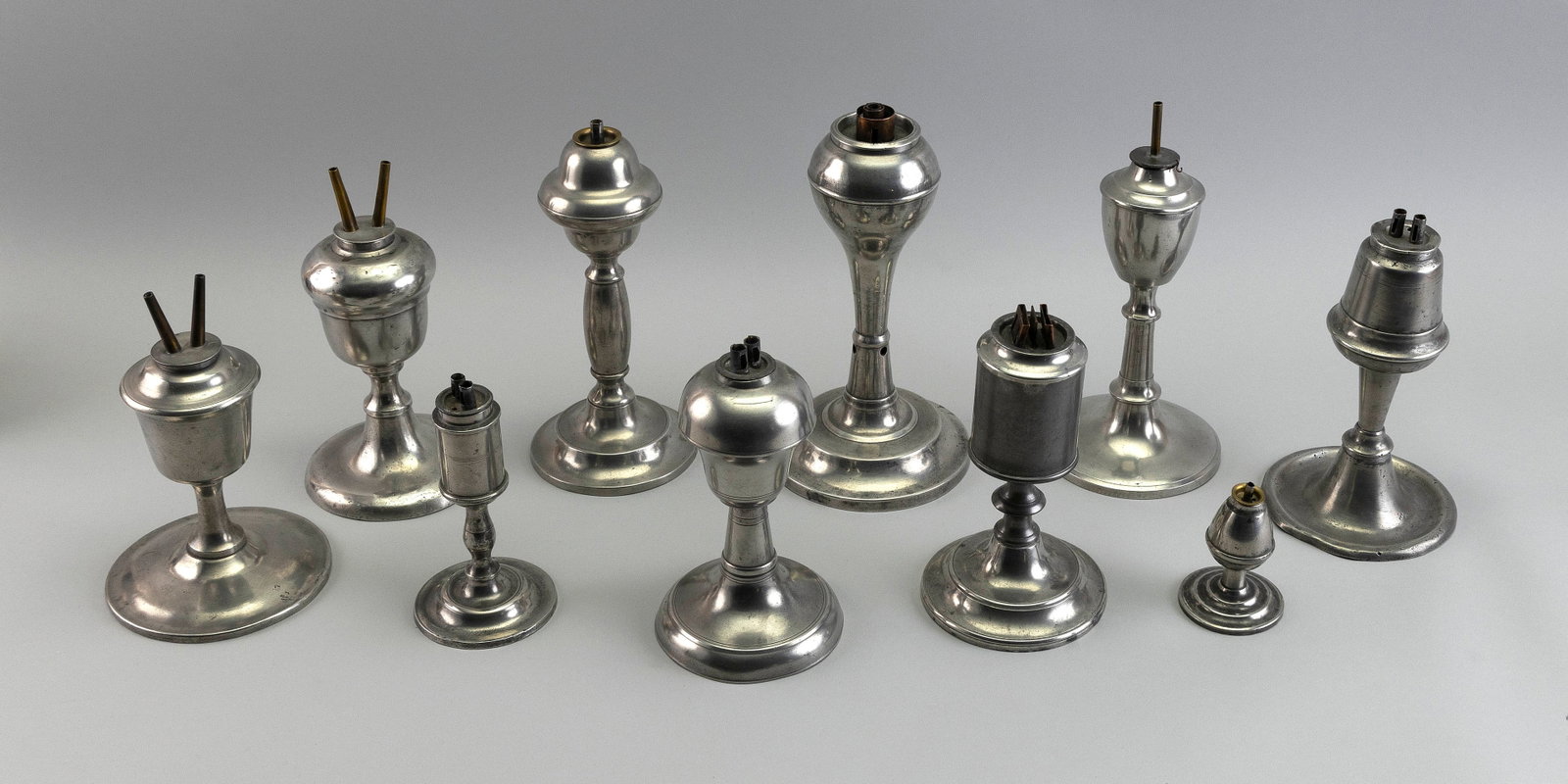 TEN AMERICAN PEWTER LAMPS, MOSTLY WHALE OIL 19th Century Heights from 2.75" to 8.5".: TEN AMERICAN PEWTER LAMPS, MOSTLY WHALE OIL 19th Century Varied forms. Heights from 2.75" to 8.5".