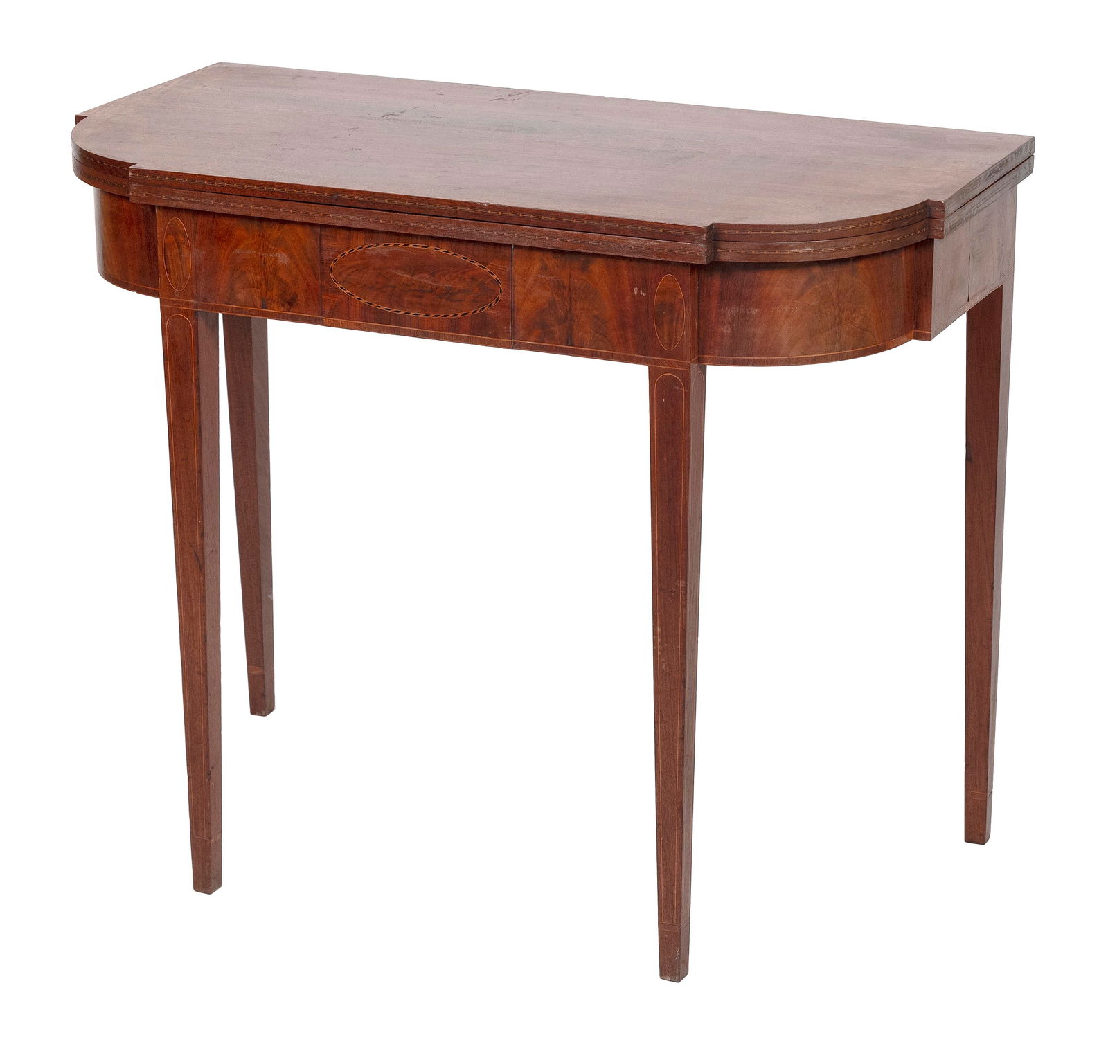 HEPPLEWHITE CARD TABLE IN THE MANNER OF WILLIAM FISK Boston, Circa 1790 Height 29.5". Width 35.5".: HEPPLEWHITE CARD TABLE IN THE MANNER OF WILLIAM FISKBoston, Circa 1790In mahogany and mahogany veneer. Edge of top with geometric string inlay. Skirt with central raised panel. Tapered legs with strin