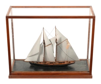 CASED MODEL OF A TWO-MASTED SCHOONER Early 20th Century Case height 16". Length 20.5". Width 7.75".