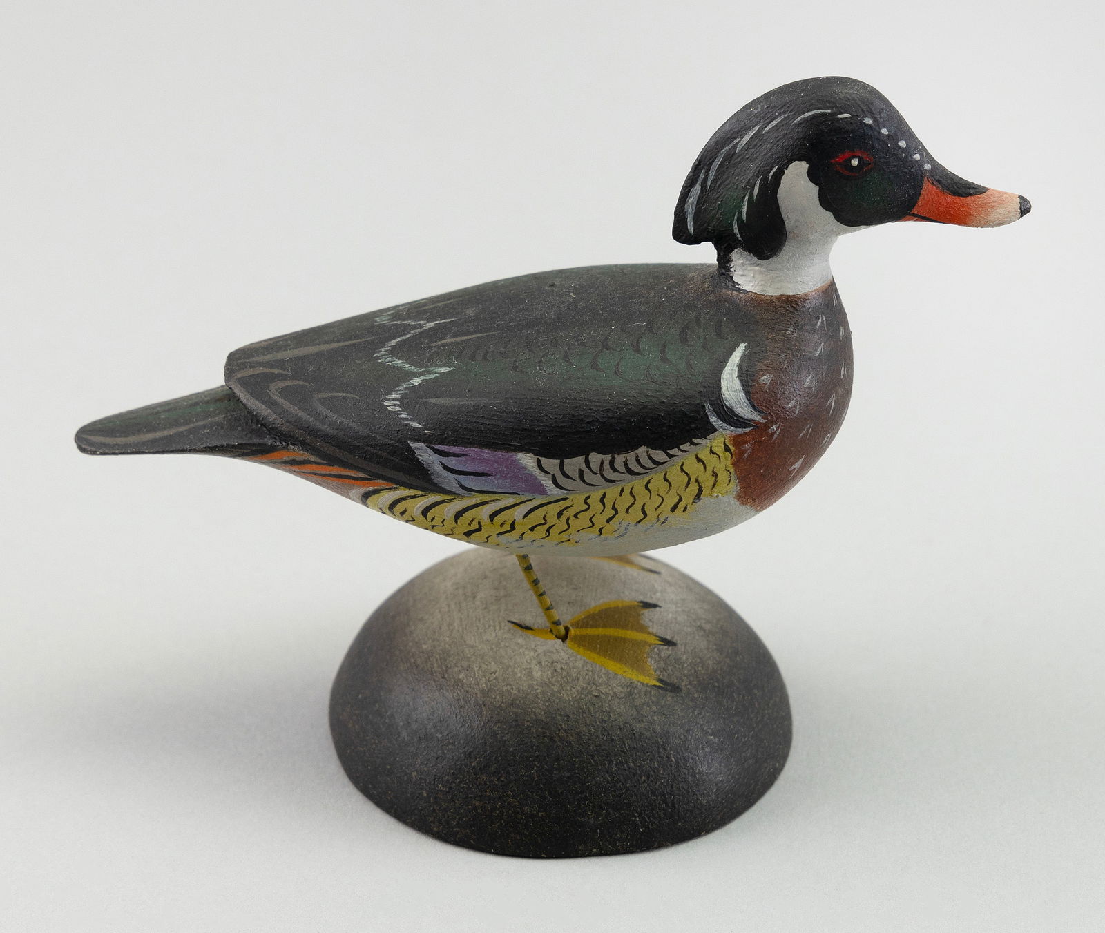 A. ELMER CROWELL MINIATURE WOOD DUCK DRAKE East Harwich, Massachusetts, 1862-1952 Height 3.25".: A. ELMER CROWELL MINIATURE WOOD DUCK DRAKEEast Harwich, Massachusetts, 1862-1952Circa 1935. Mounted on a round base. Rectangular stamp.Height 3.25".