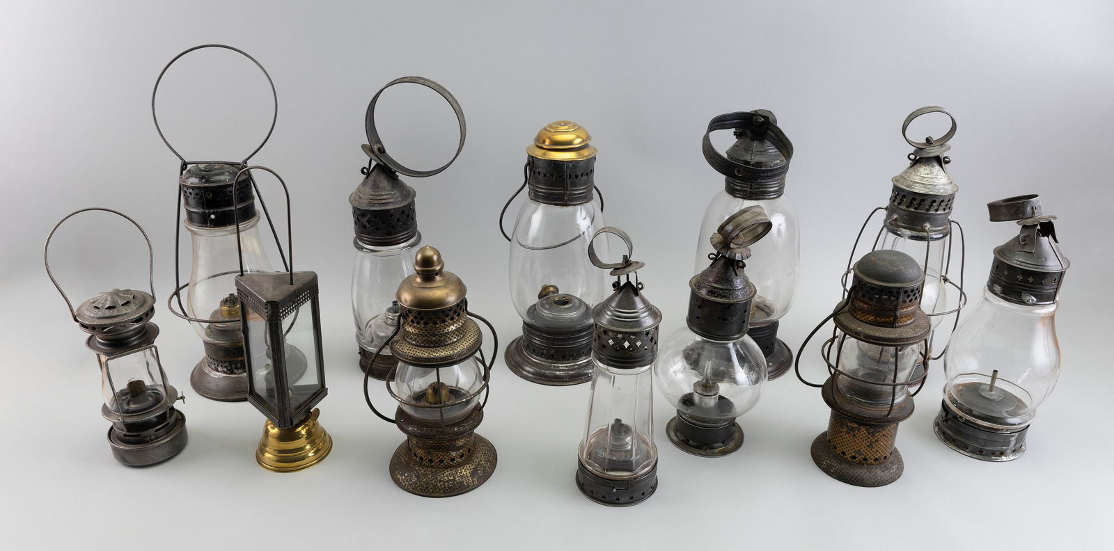 TWELVE TIN AND BRASS LANTERNS America, 19th Century Heights from 8.25" to 13.5". (1 of 1)