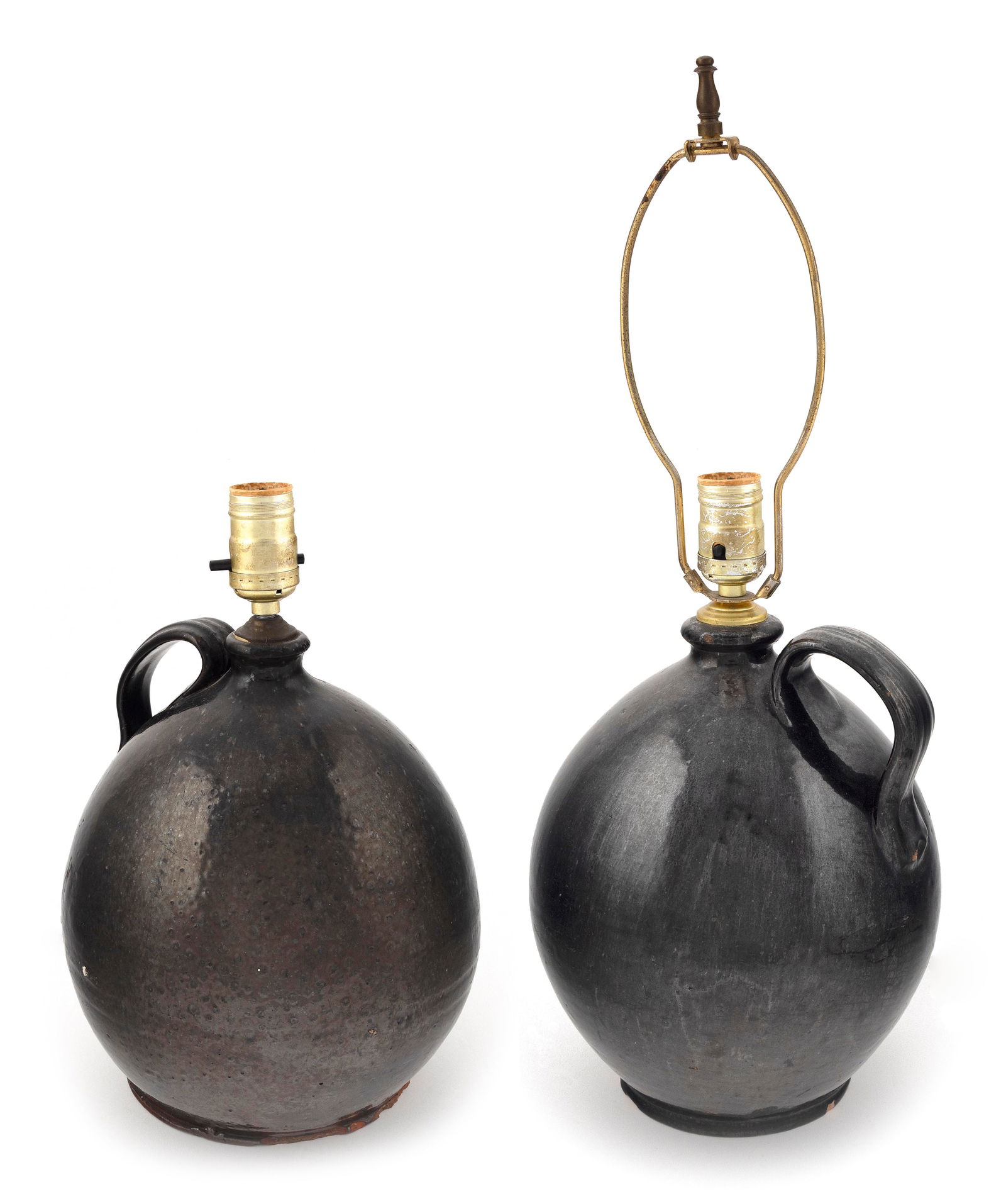 TWO REDWARE JUGS America, 19th Century Jug heights 10" and 10.5".: TWO REDWARE JUGSAmerica, 19th CenturyBoth with applied strap handles. Mounted as table lamps.Jug heights 10" and 10.5". Provenance:The Collection of Bob & Nancy Skinner.