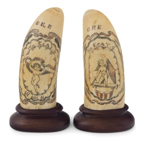 PAIR OF POLYCHROME SCRIMSHAW WHALE'S TEETH WITH CHERUBS Circa 1860 Lengths 5.5". Include wooden
