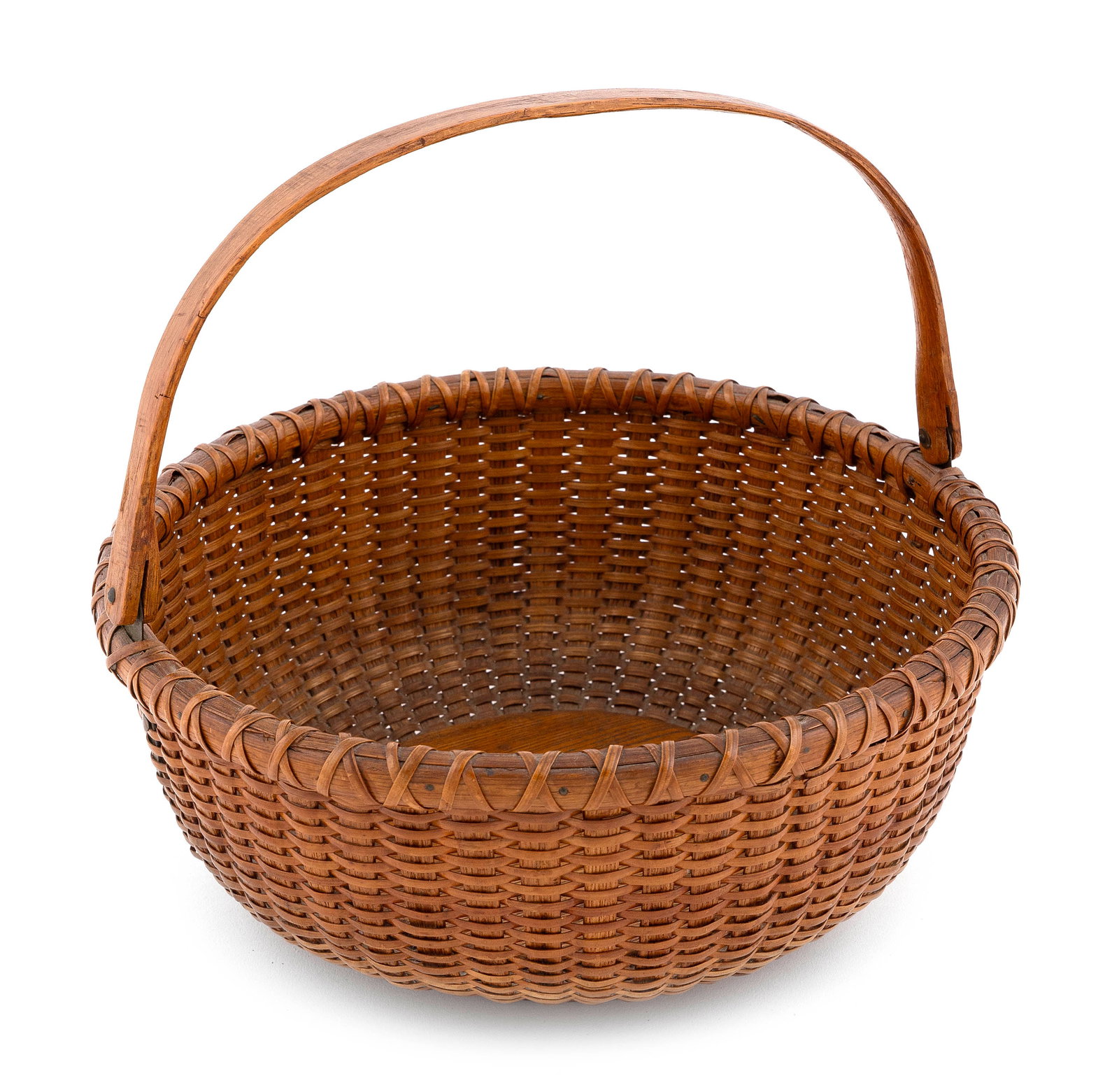 FERDINAND SYLVARO NANTUCKET BASKET Nantucket, 1868-1952 Height to rim 4.5". Diameter 10.5".: FERDINAND SYLVARO NANTUCKET BASKET Nantucket, 1868-1952 Round, with swing handle. Label on underside handwritten "Made by Ferdinand Sylvaro 97 Orange St. Nantucket Mass". Height to rim 4.5". Diameter 