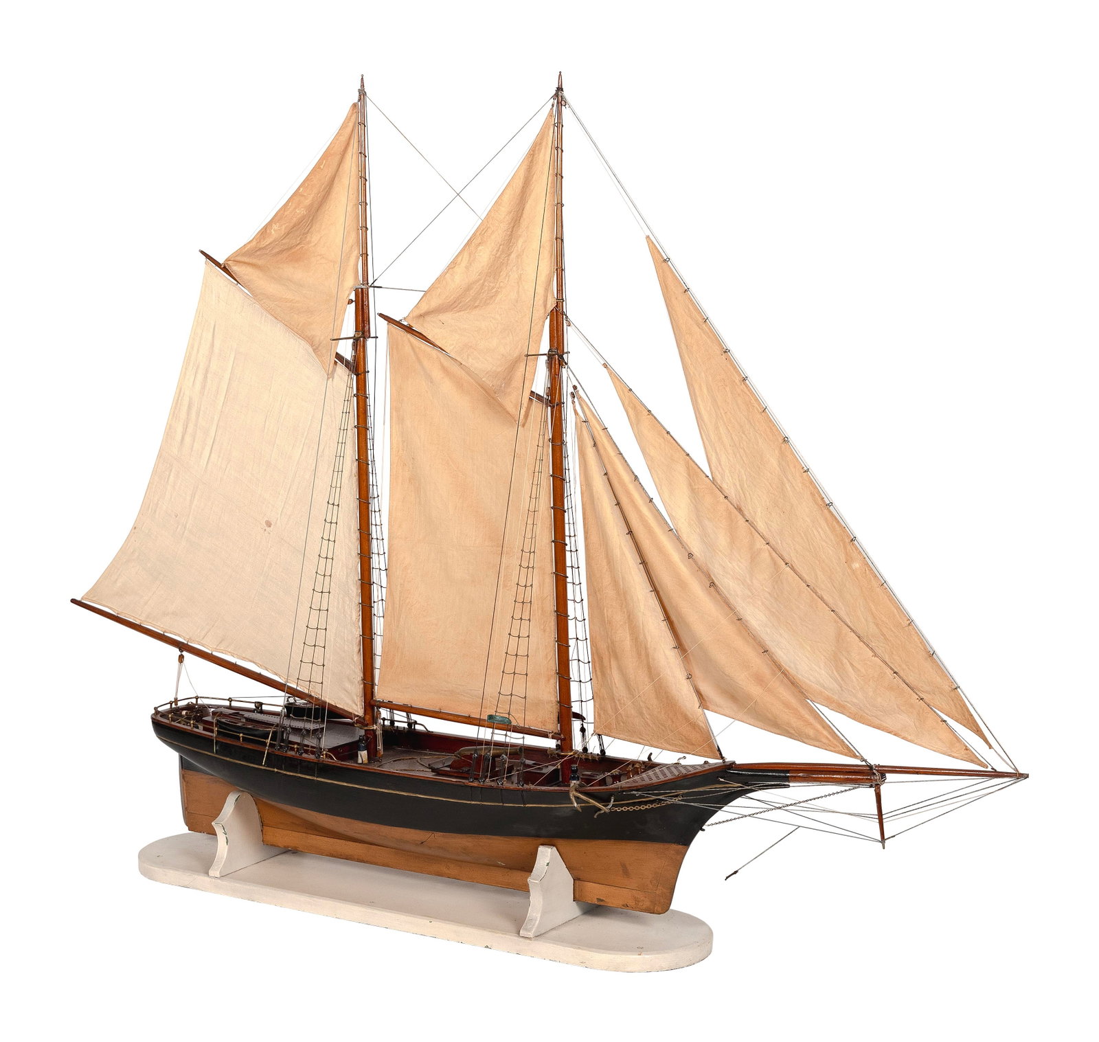 MODEL OF THE TWO-MASTED SCHOONER "WANDERER" First Half of the 20th Century Total height 42". Length: MODEL OF THE TWO-MASTED SCHOONER "WANDERER" First Half of the 20th Century Black hull with a copper-colored bottom. Beautifully detailed deck brightworks. Set sails. Displayed on a wooden cradle. Tota