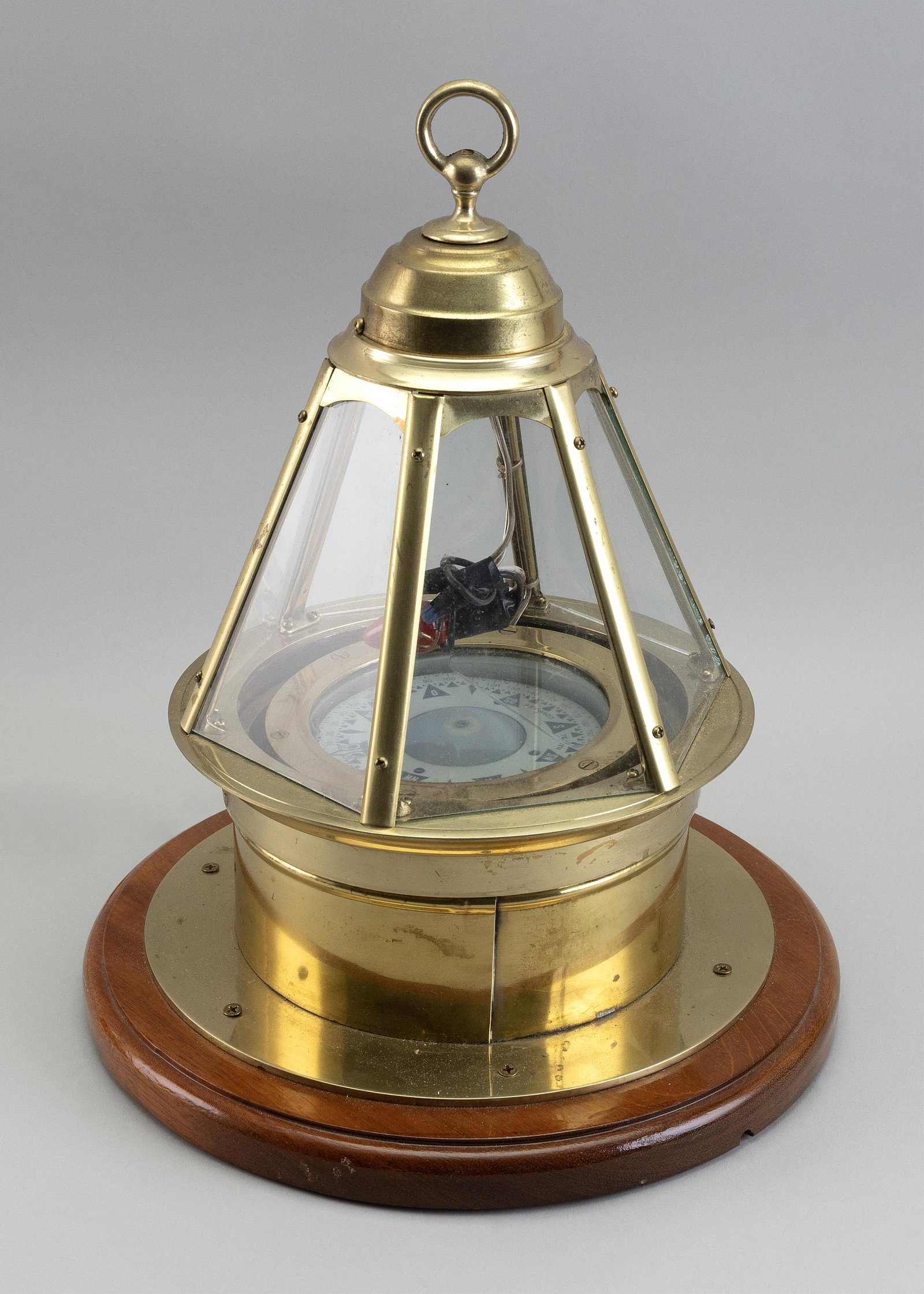 BRASS SKYLIGHT BINNACLE Late 19th/Early 20th Century Total height 16". Base diameter 12.5".: BRASS SKYLIGHT BINNACLE Late 19th/Early 20th Century Fitted with a wet compass and mounted on a mahogany base. Total height 16". Base diameter 12.5".