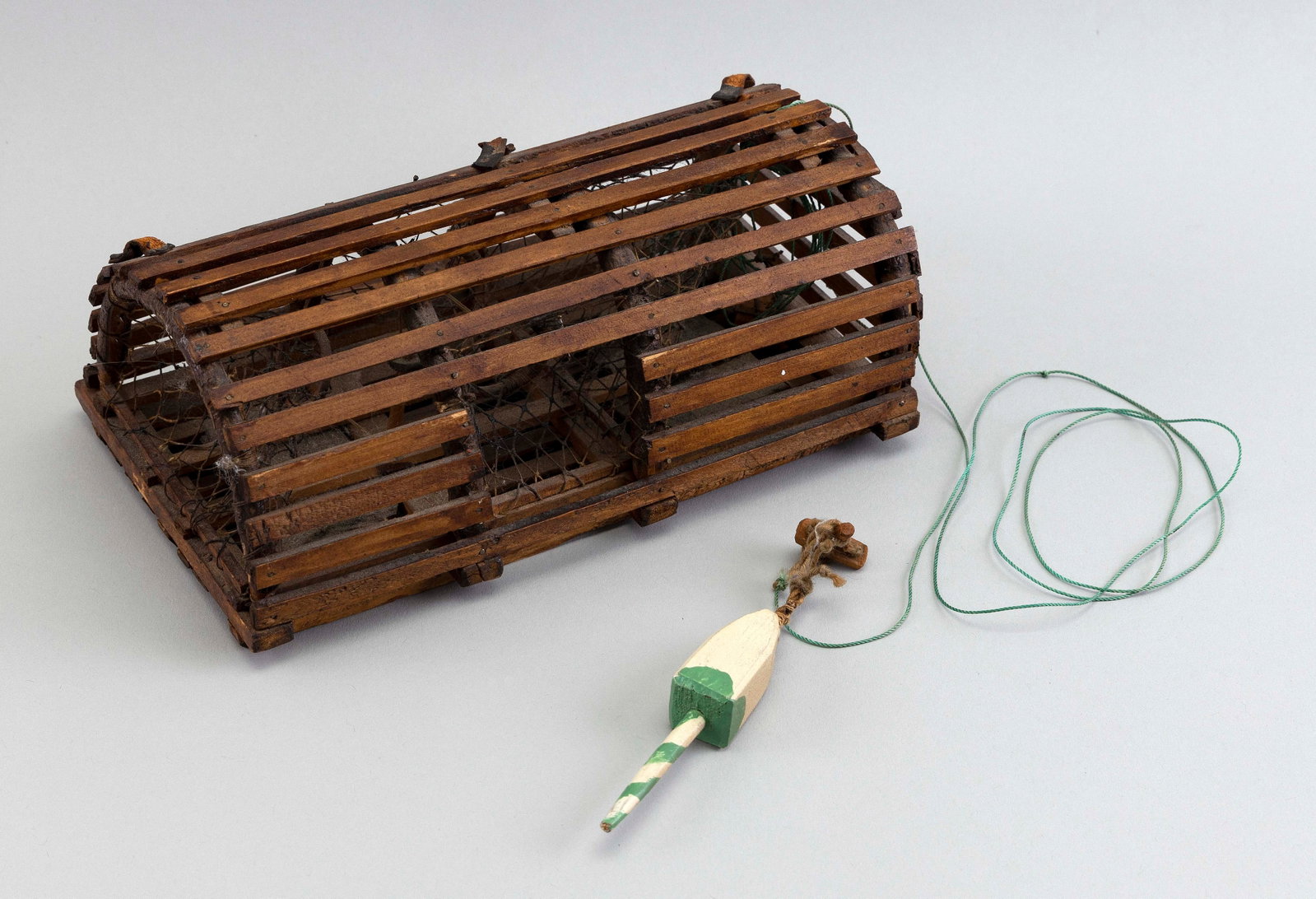 LOBSTER TRAP, POSSIBLY A SALESMAN'S SAMPLE OR MODEL First Half of the 20th Century Height 3". Length: LOBSTER TRAP, POSSIBLY A SALESMAN'S SAMPLE OR MODEL First Half of the 20th Century Complete with buoy, nets, hinged trap door, etc. Height 3". Length 8.75". Width 5".