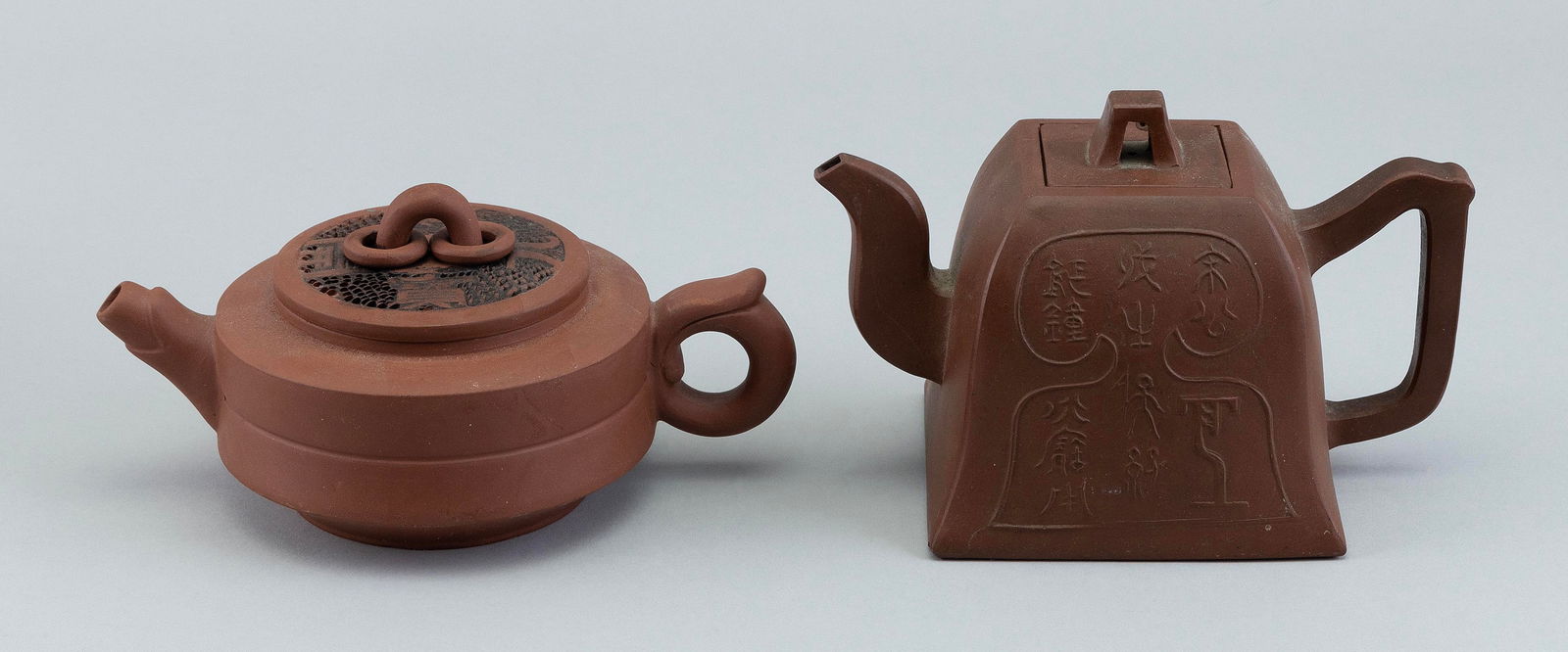 TWO CHINESE YIXING POTTERY TEAPOTS Late 19th/Early 20th Century Heights from 3.5" to 4.5". (1 of 3)