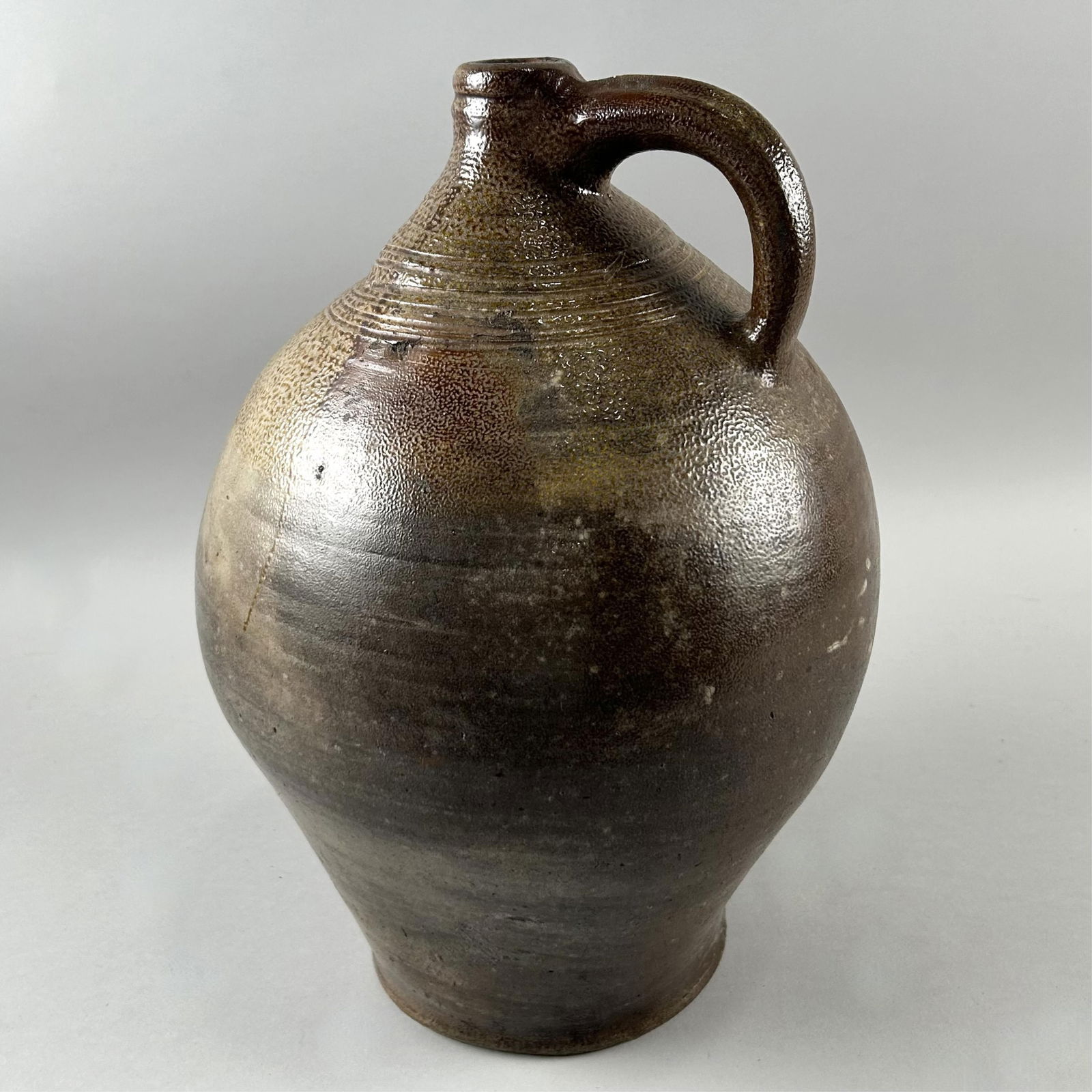 TWO-GALLON STONEWARE JUG Boston, 19th Century Height 14". (1 of 3)