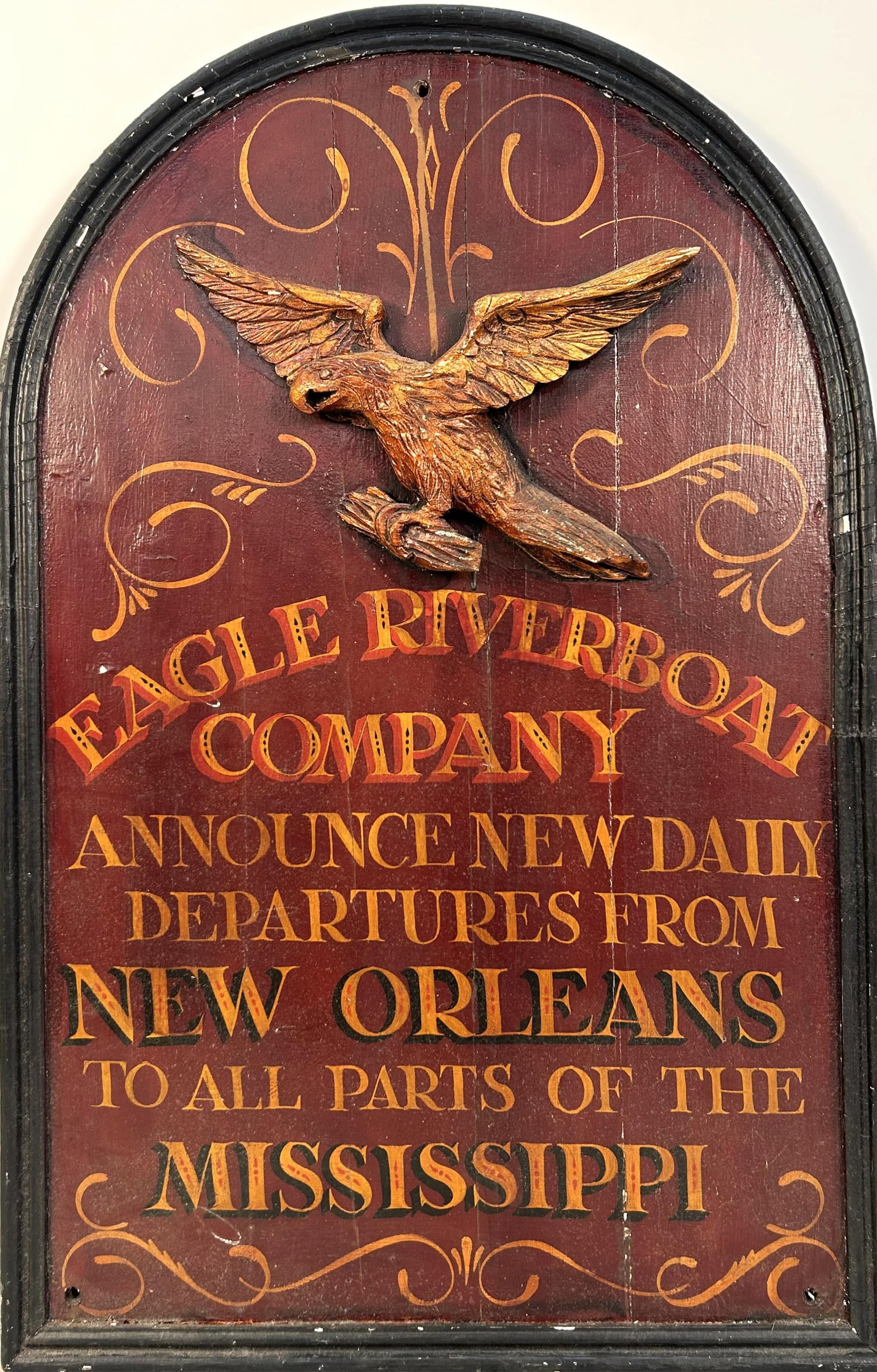 REPRODUCTION RIVERBOAT COMPANY SIGN Late 20th Century Height 36.25".: REPRODUCTION RIVERBOAT COMPANY SIGN Late 20th Century Applied eagle above "Eagle Riverboat Company Announce New Daily Departures from New Orleans to all Parts of the Mississippi" in gold lettering on 