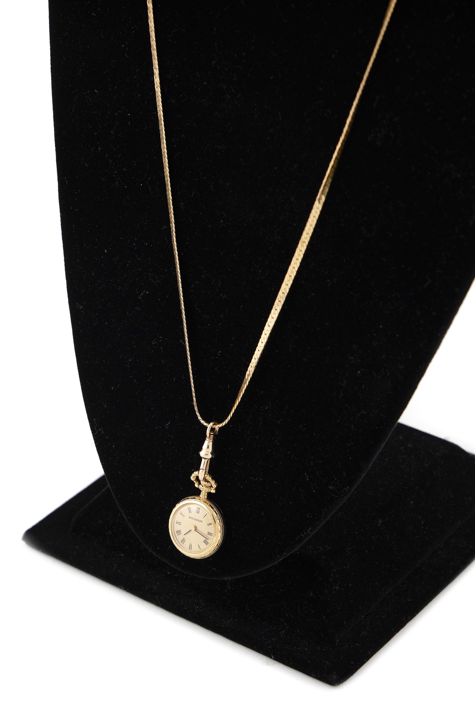 BUCHERER 18KT YELLOW GOLD PENDANT WATCH ON 14KT YELLOW GOLD CHAIN Approx. 13.56 total dwt.: BUCHERER 18KT YELLOW GOLD PENDANT WATCH ON 14KT YELLOW GOLD CHAIN17-jewel Bucherer movement. Champagne dial with black hands and black Roman numerals. Case diameter 20.0mm. S-link flat chain with spri