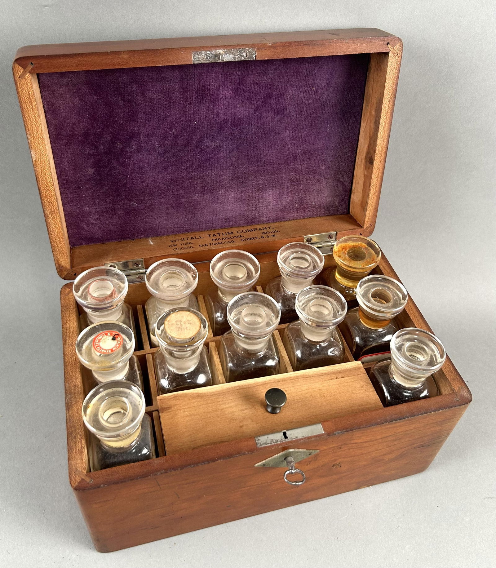 WHITALL TATUM COMPANY APOTHECARY CHEST America and Australia, Circa 1890 Height 5". Width 9". Depth: WHITALL TATUM COMPANY APOTHECARY CHESTAmerica and Australia, Circa 1890Fitted maple chest containing 12 glass bottles.Height 5". Width 9". Depth 5.5".