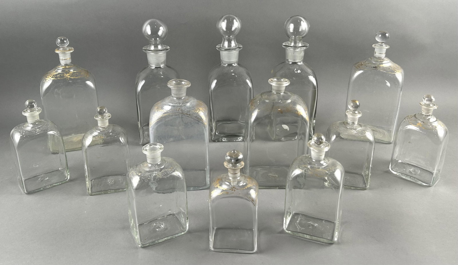 FOURTEEN CLEAR GLASS DECANTERS 19th Century Heights from 7" to 11". (1 of 5)