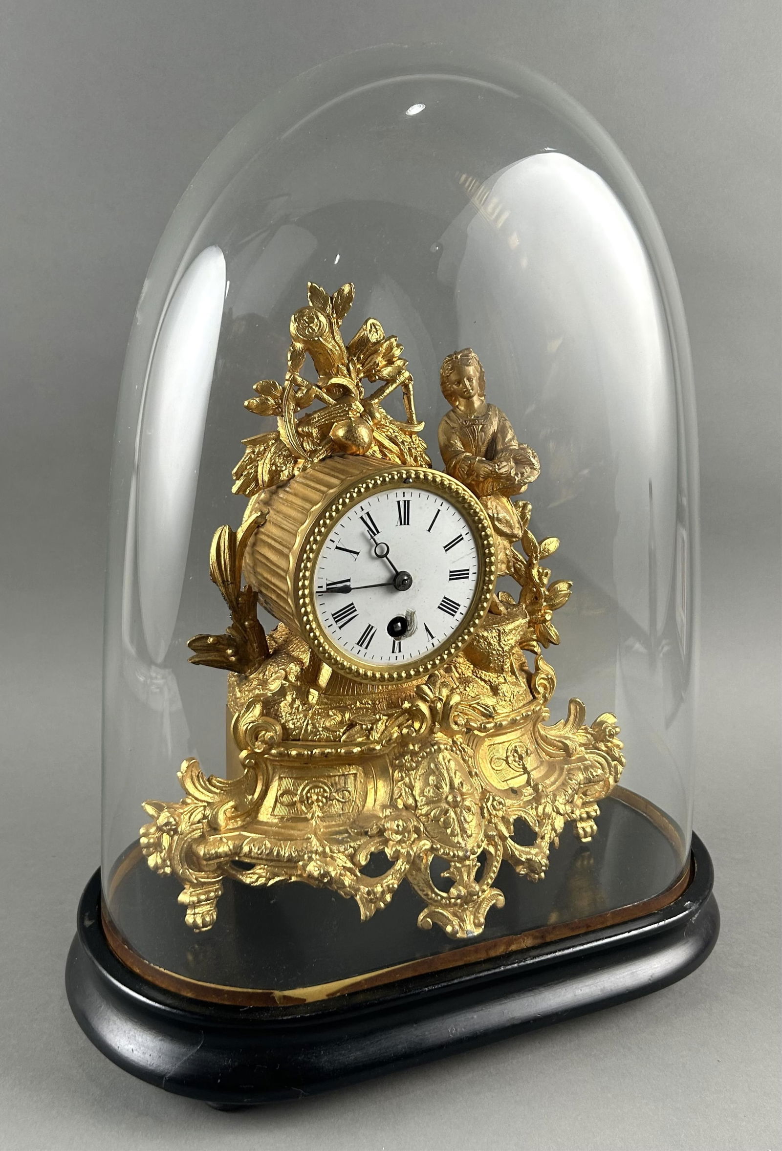GILT SPELTER MANTEL CLOCK WITHIN A GLASS DOME France, Mid-to Late 19th Century Total height 16.5". (1 of 3)