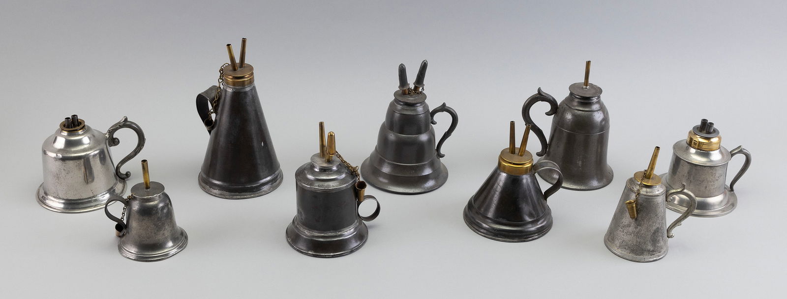 NINE PEWTER AND TIN HAND LAMPS America, 19th Century Heights from 4" to 5.75". (1 of 1)